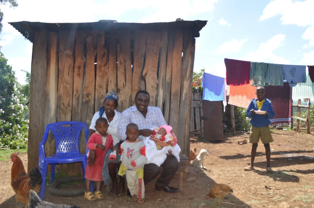 Four day old Baby Jane posing for a picture in front of their family home, where she and her three brothers were born.