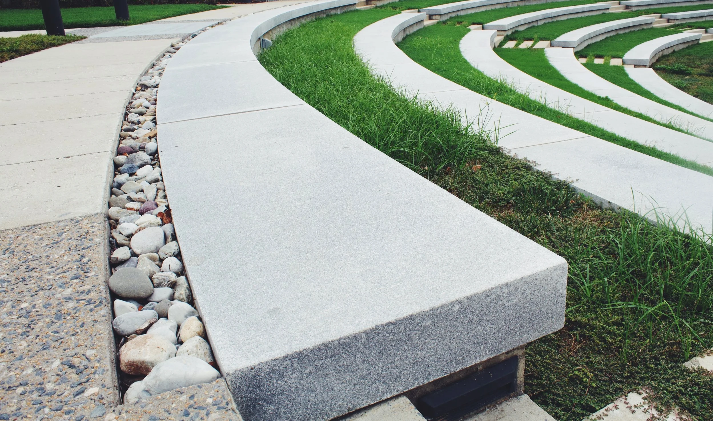 The strip of river rocks at the beginning of the amphitheater is not only a beautiful detail and transition to new material in the landscape, but also a functional and smart stormwater management element to capture excess water from the steep hills …