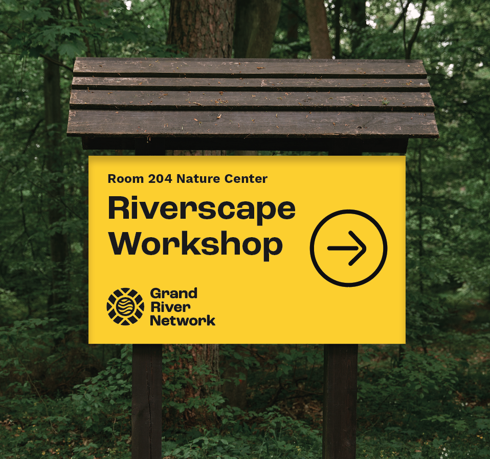 Yellow sign in a forest pointing to a riverscape workshop at Room 204 Nature Center, organized by Grand River Network