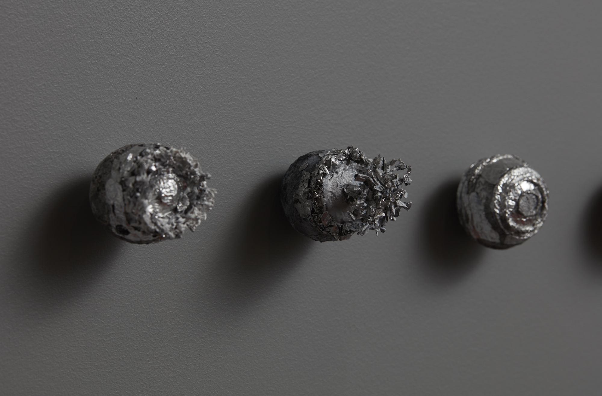 Brendon Wilkinson Tohou Vohou I (Absolute Destruction) (detail) 2018 tinfoil, acrylic, found ball, pin dimensions variable (8 pieces)