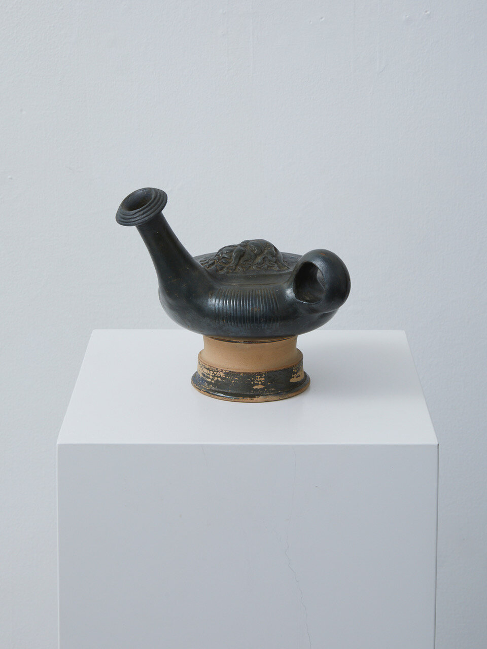 Campanian Black-Glazed Guttus Hellenistic period, 2nd half of the 4th century BC, Western Greek, Campania 135 x 150 x 115mm Provenance: L.J. collection, Netherlands; Private collection, USA. Campanian black-glazed guttus made from toned clay wi