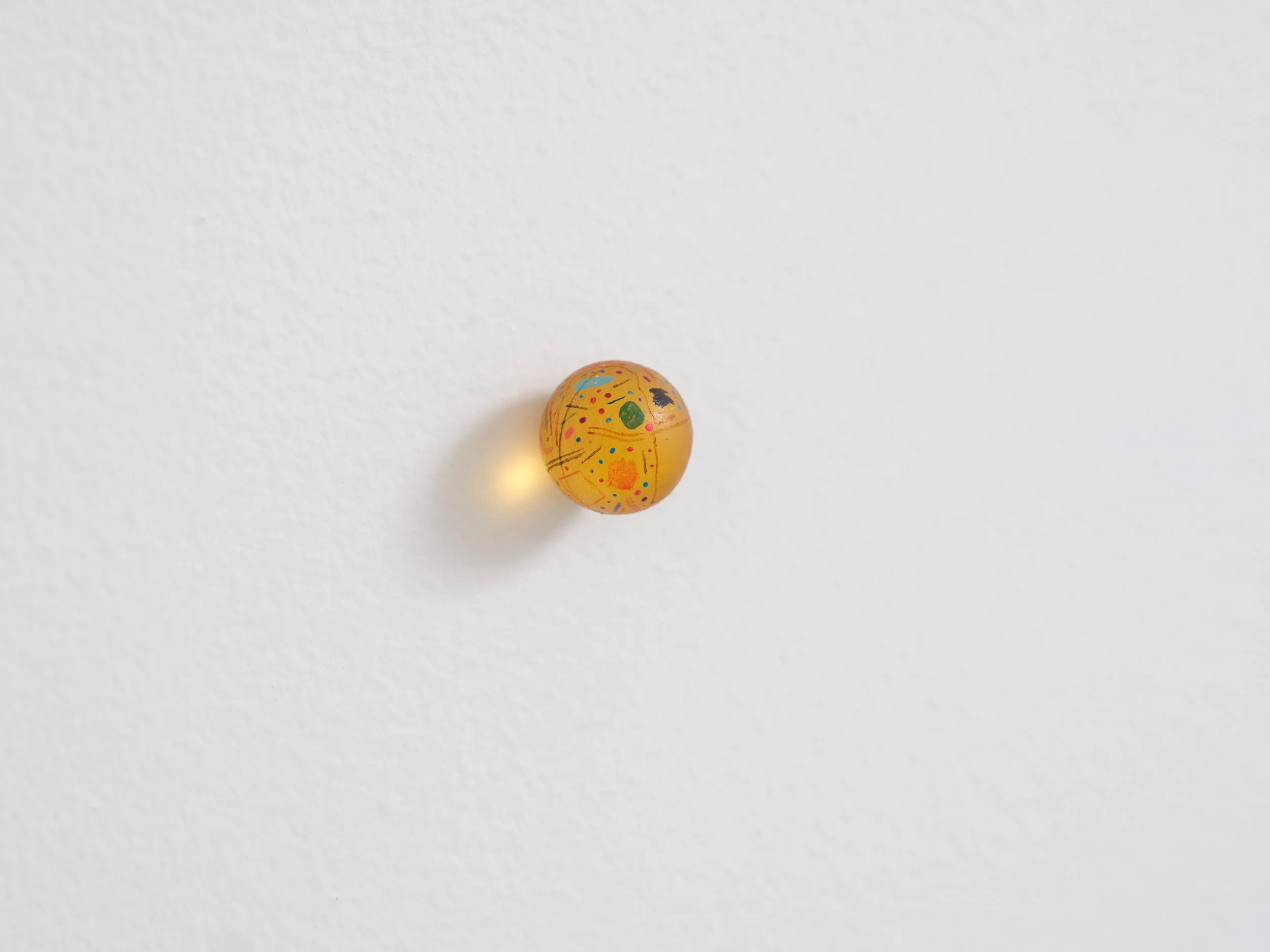   No title  (detail) 2021 Acrylic and varnish on resin and wood 24 parts, each part 15mm diameter  