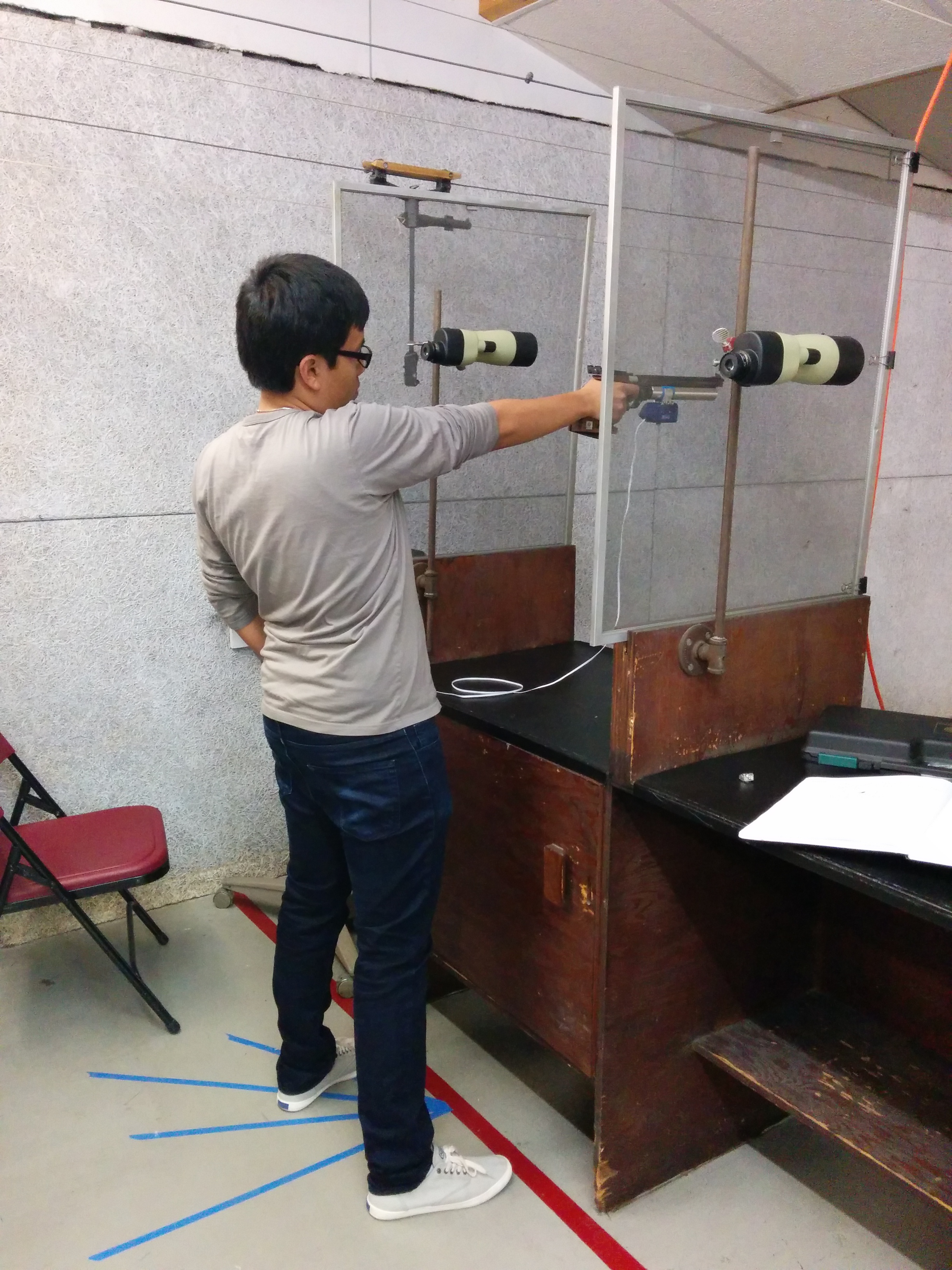In Olympic-style shooting, the pistol is operated from a standing, unsupported position. I am shown executing a standard shot process.