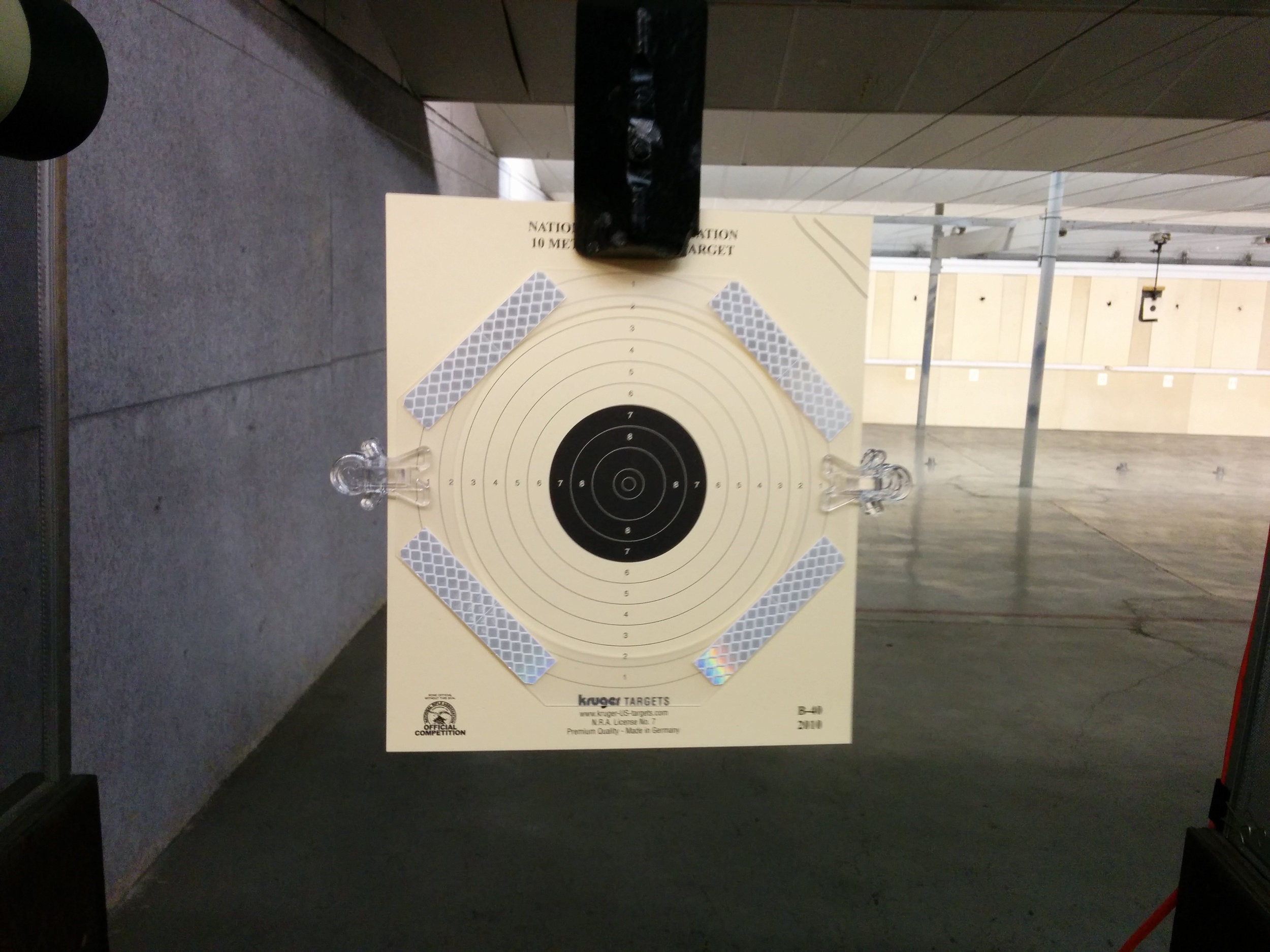 The testing setup included a 10m air pistol target with reflective tape.