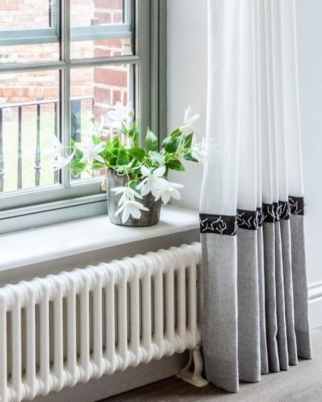 Beautiful sheer curtains in this conservatory we designed a couple of years ago.  The contrast on the bottom of the curtains with trim and darker shade gives so much definition to the room.