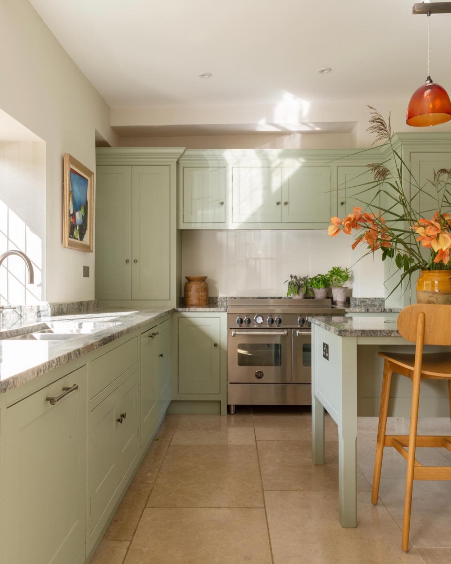 Loving autumn and all of its wonderful colours. The soft light in this gorgeous farmhouse kitchen we designed a few years ago makes the colours in the artwork and lighting pop.  #autumn #farmhouse #shakerkitchen #kitchen