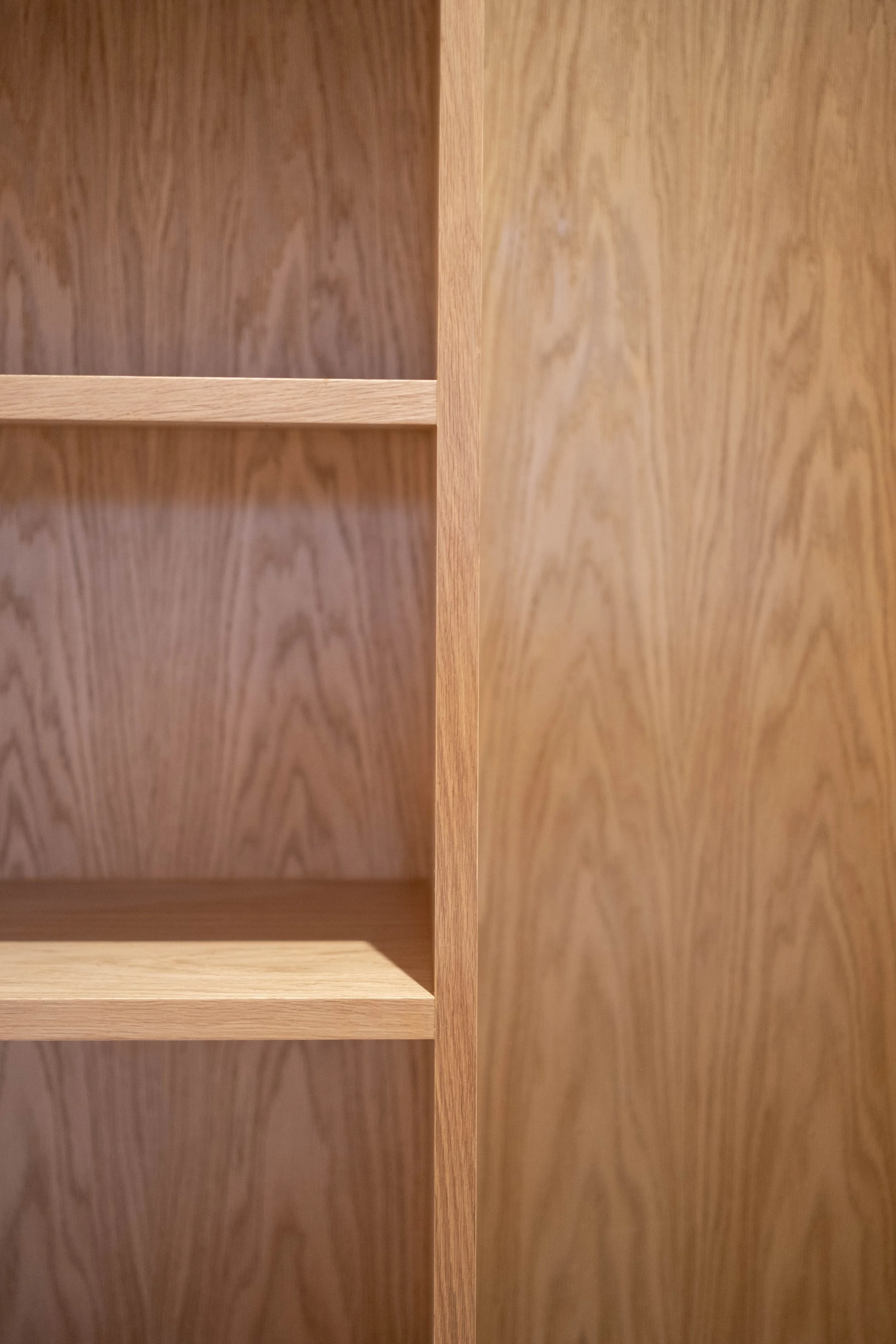 Close-up of a wooden bookshelf with multiple horizontal and vertical panels.