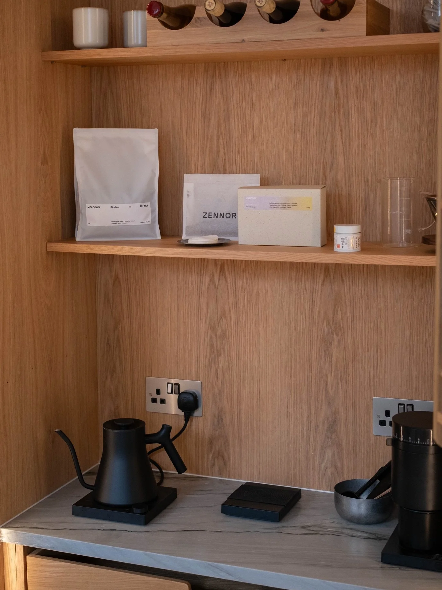 Quartzite is a great option for kitchen worktops as it is a durable natural stone that is very low maintenance. The worktop in this coffee unit has a distinctive leather finish, grey base tones with subtle veining, and looks stunning against oak. 

#