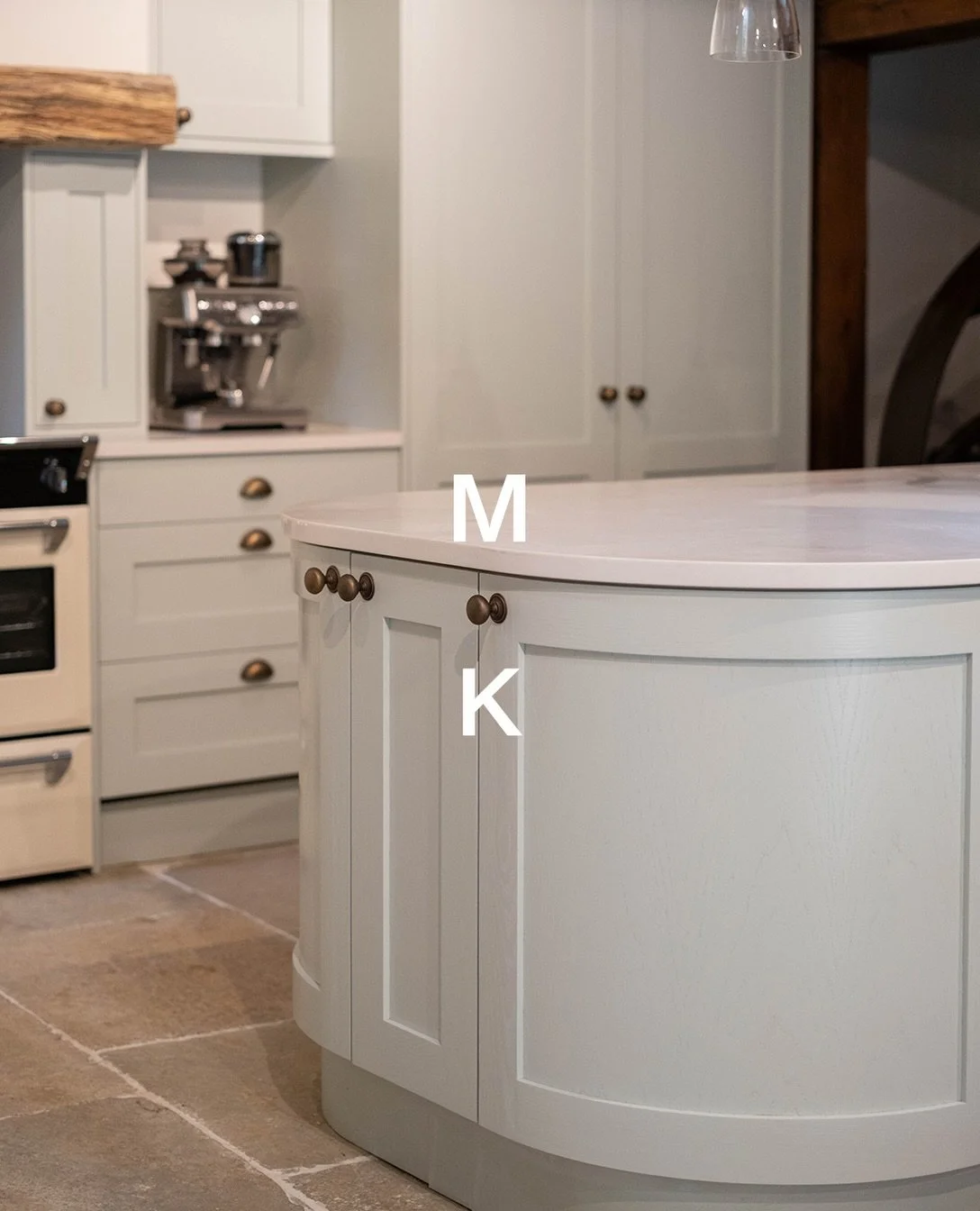 MEADOWS Kitchens. 

The kitchen we did for this project sits inside a water mill dating back to the 15th century, with much of the original machinery still built into the room. Ash shaker doors were hand made and sprayed in Dulux Heritage Green Slate