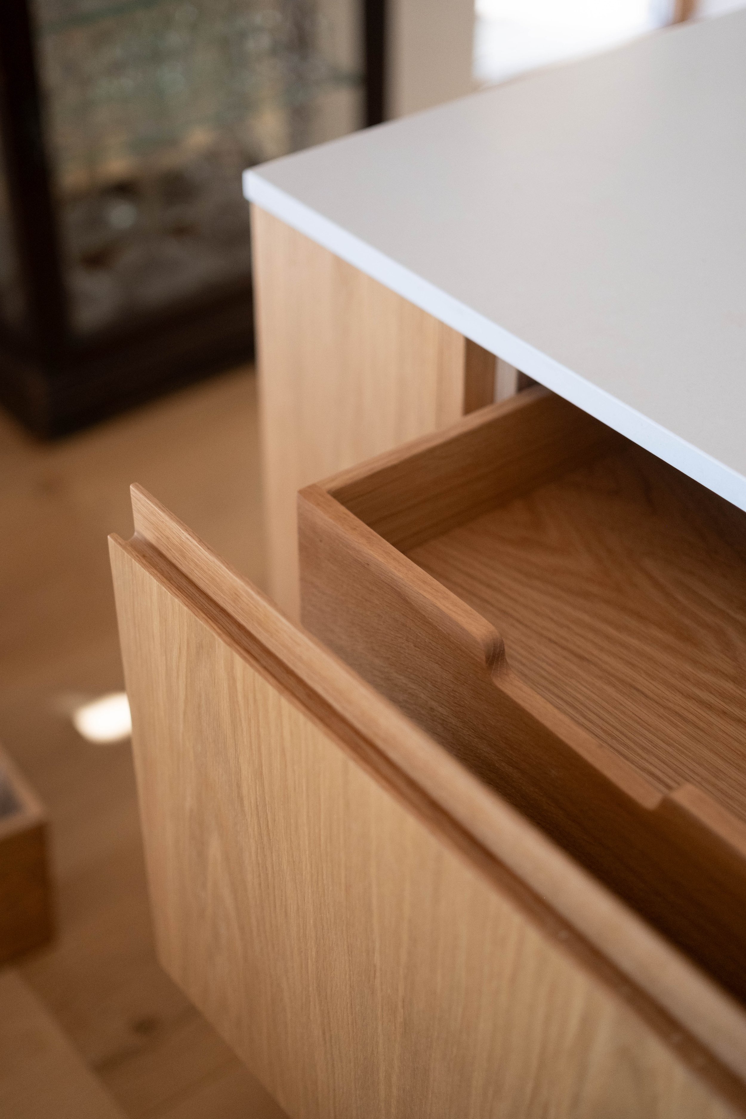 Close-up of wooden furniture drawers and cabinet with white and natural wood finish.