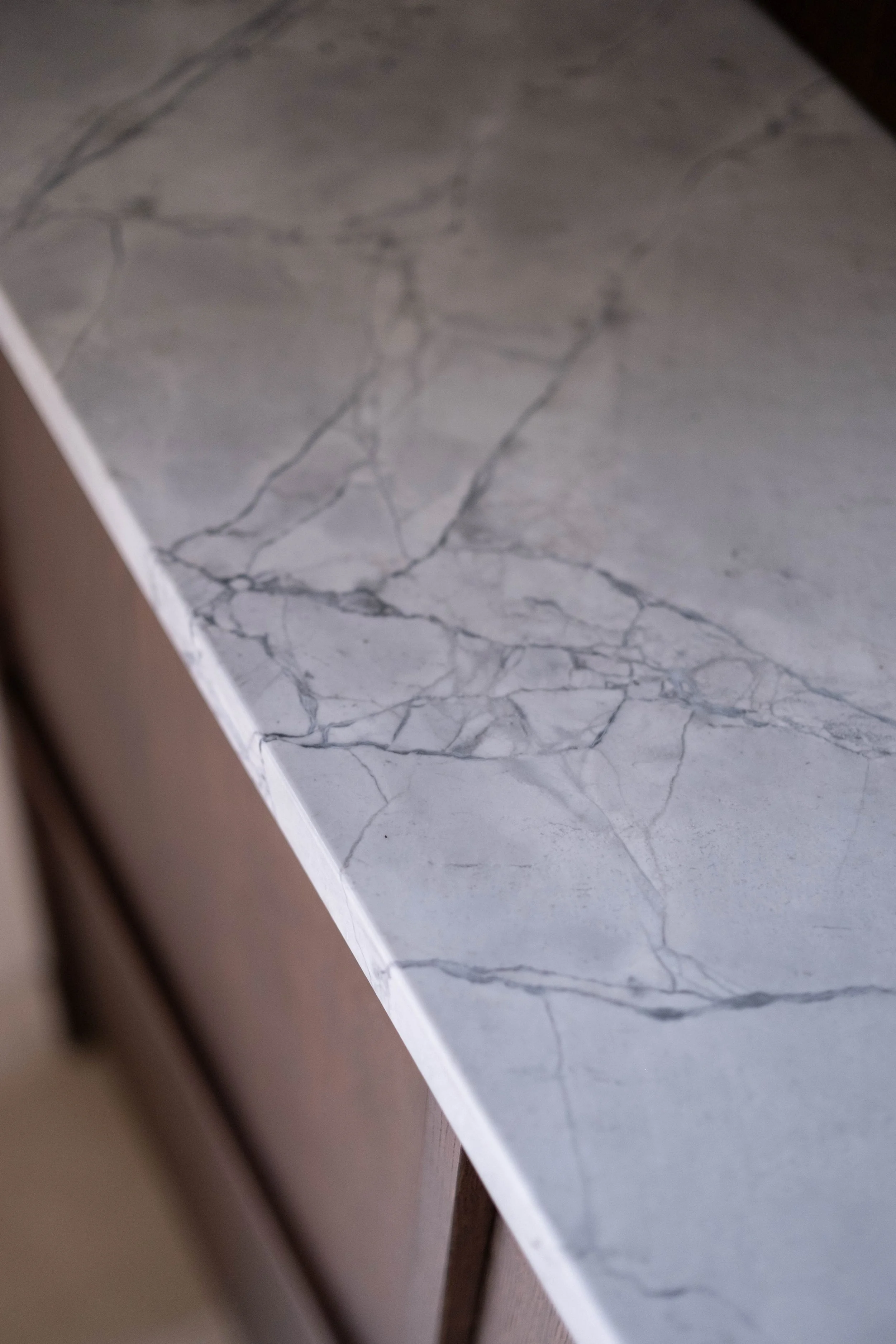 Close-up of a white marble surface with gray veining.