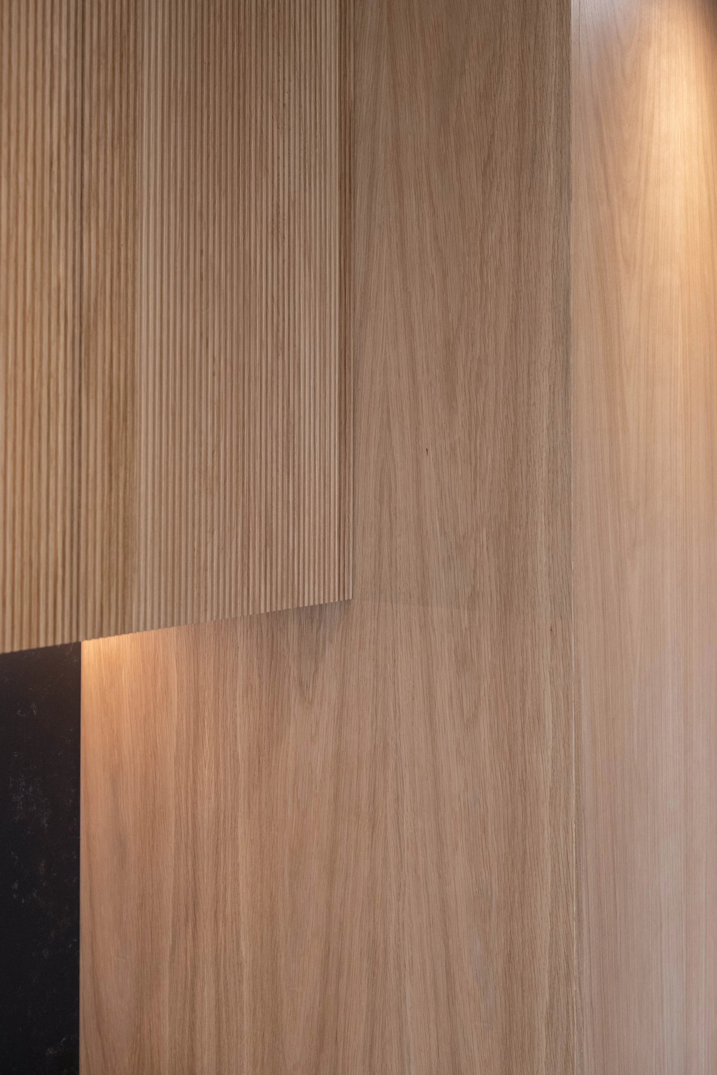 Close-up of a wooden surface showing multiple sections with a natural wood grain pattern.