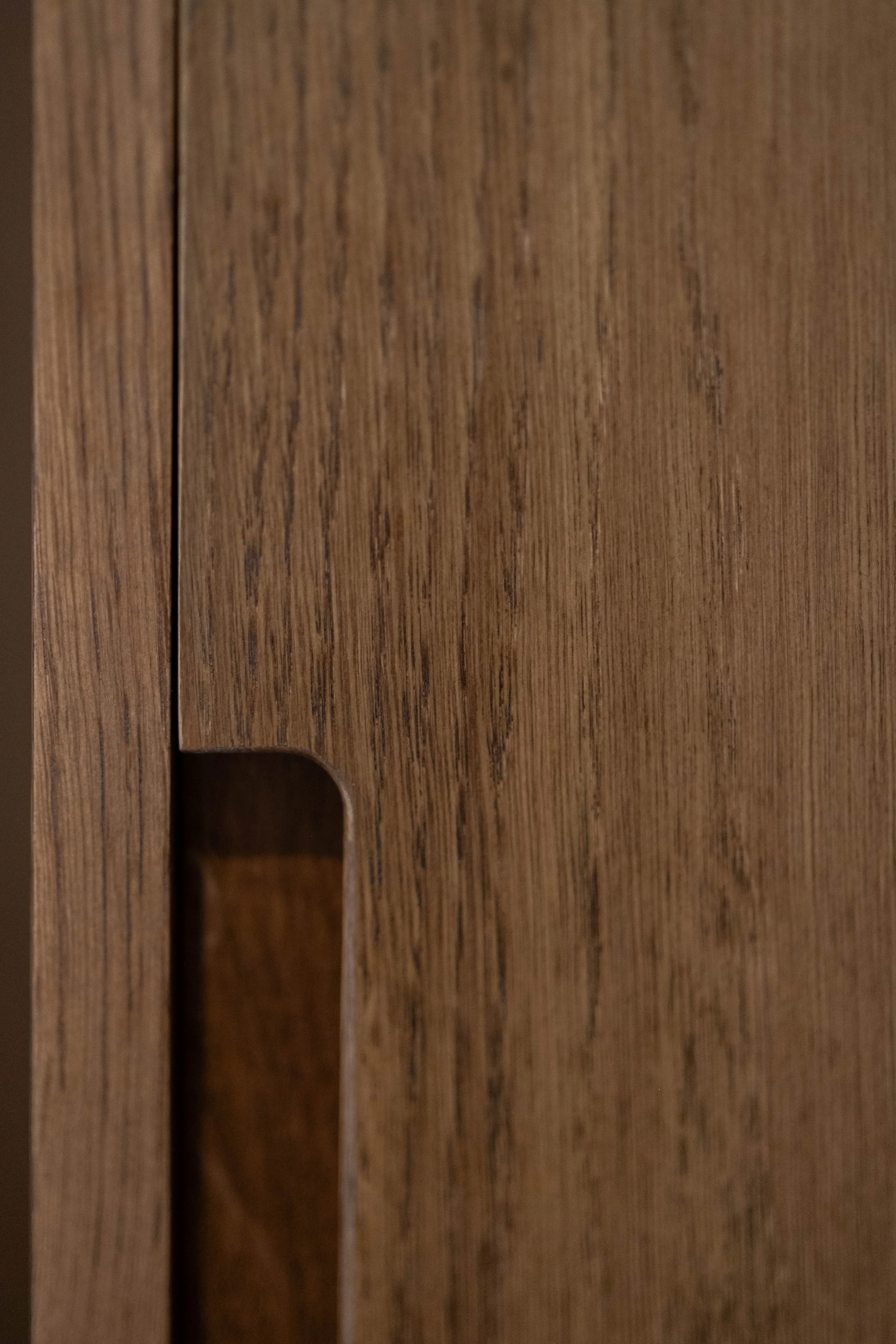 Close-up of a wooden surface with visible grain patterns and a small cutout.