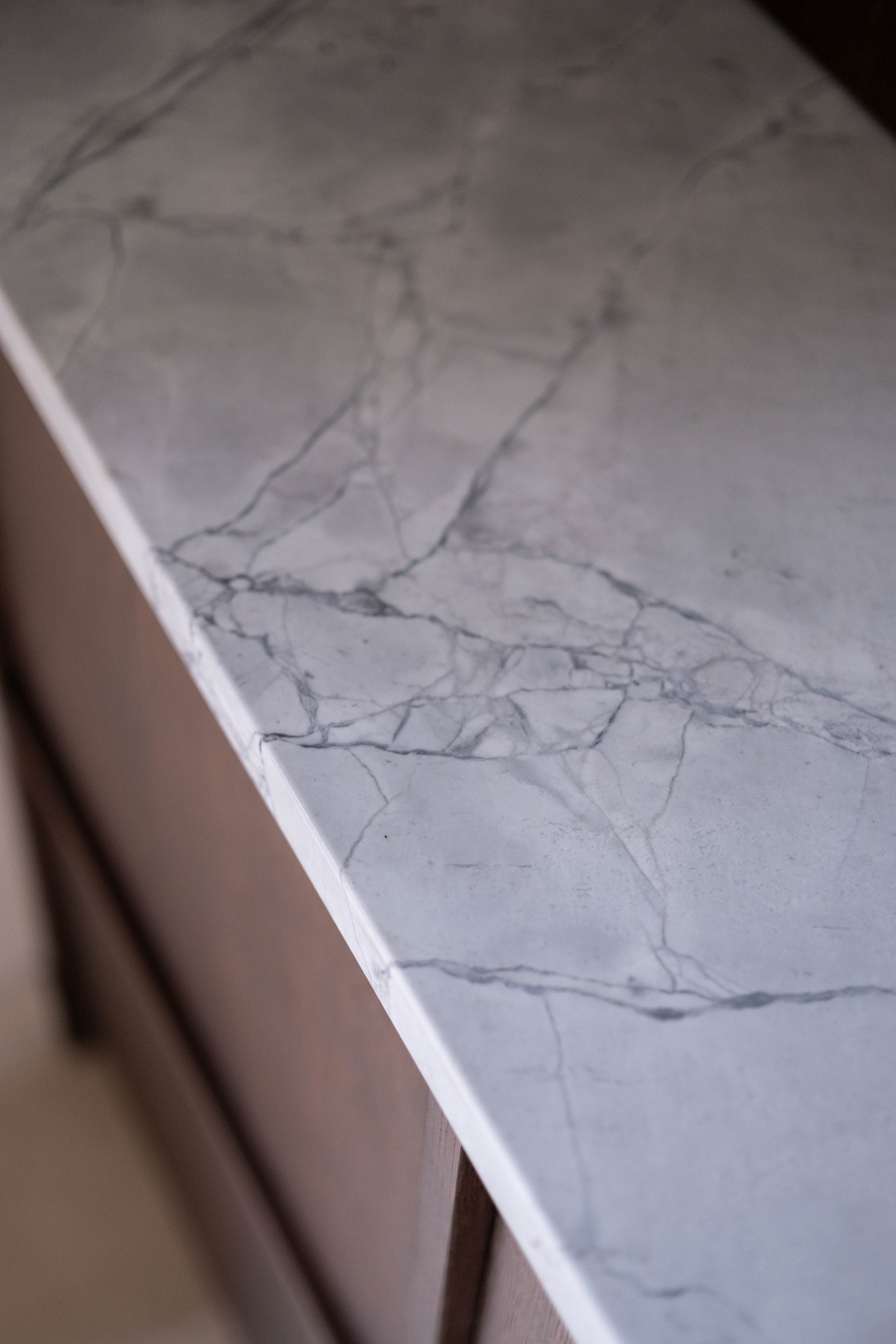 Close-up photo of a marble surface with visible dark grey veining.