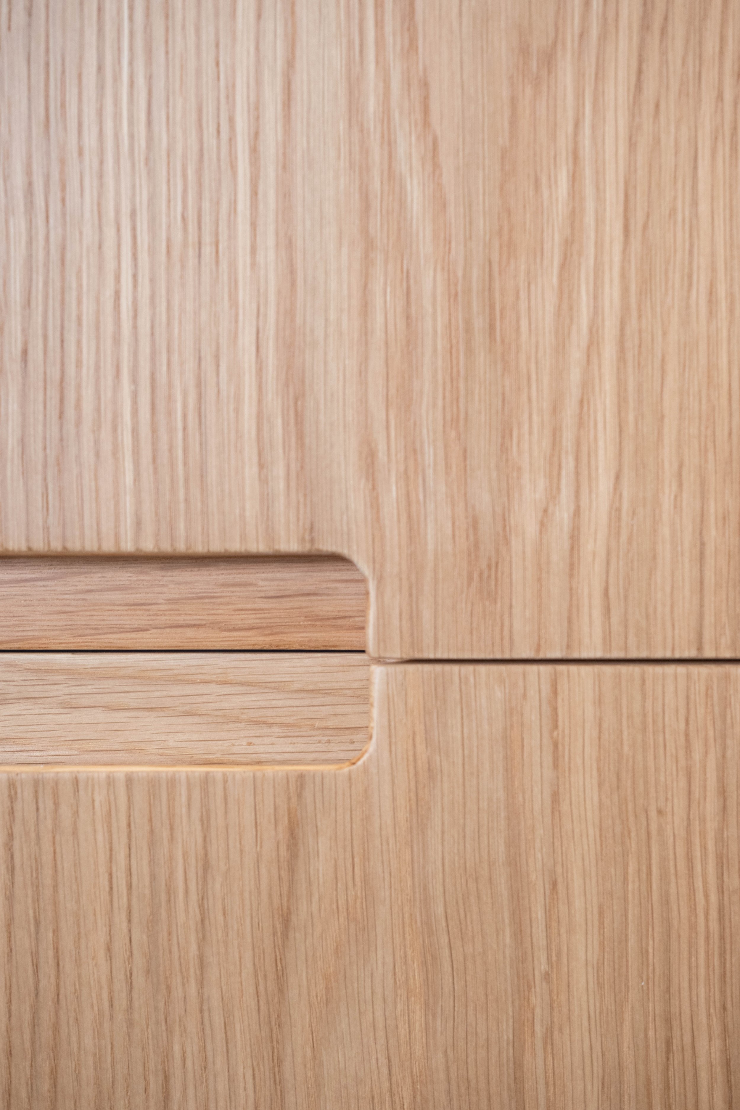 Close-up of a wooden surface with light-colored wood grain.