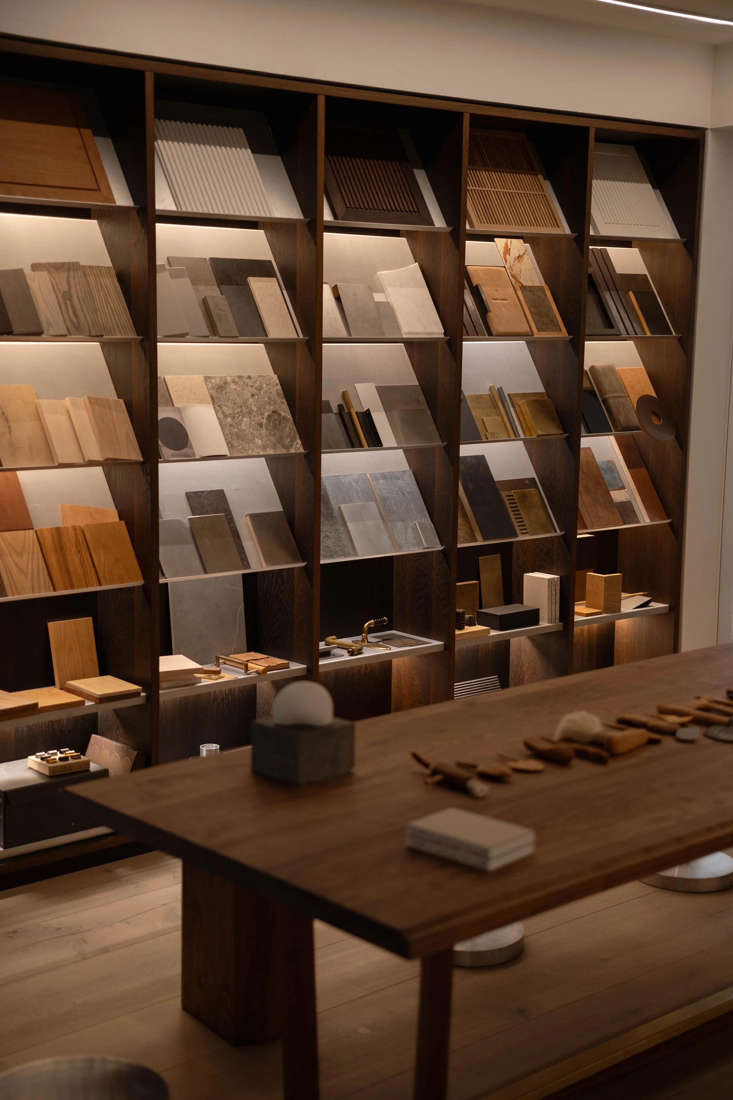 Display of various tile samples arranged on shelves in a store or showroom.