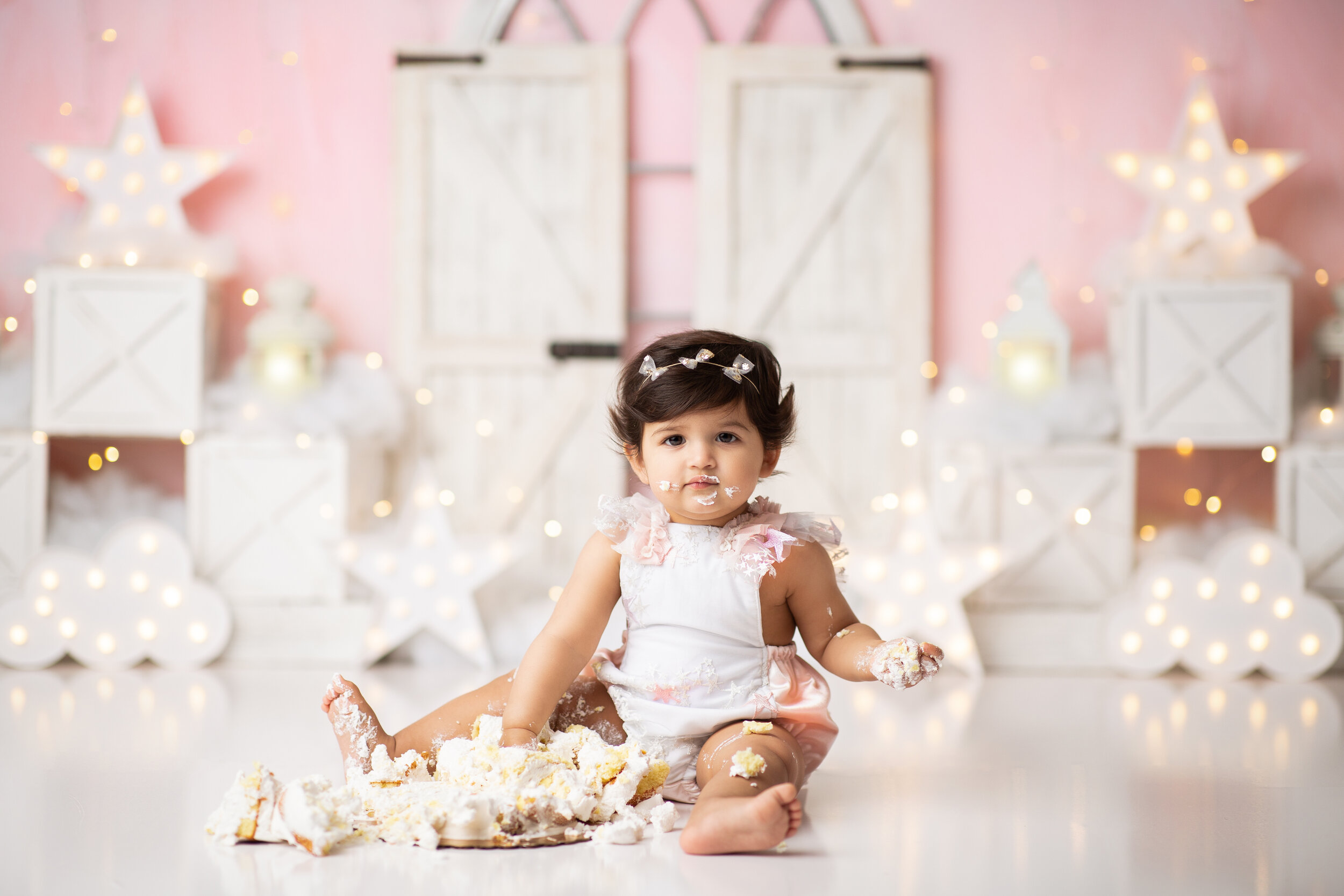  Baby with a smashed cake in New Jersey studio during her first birthday session 