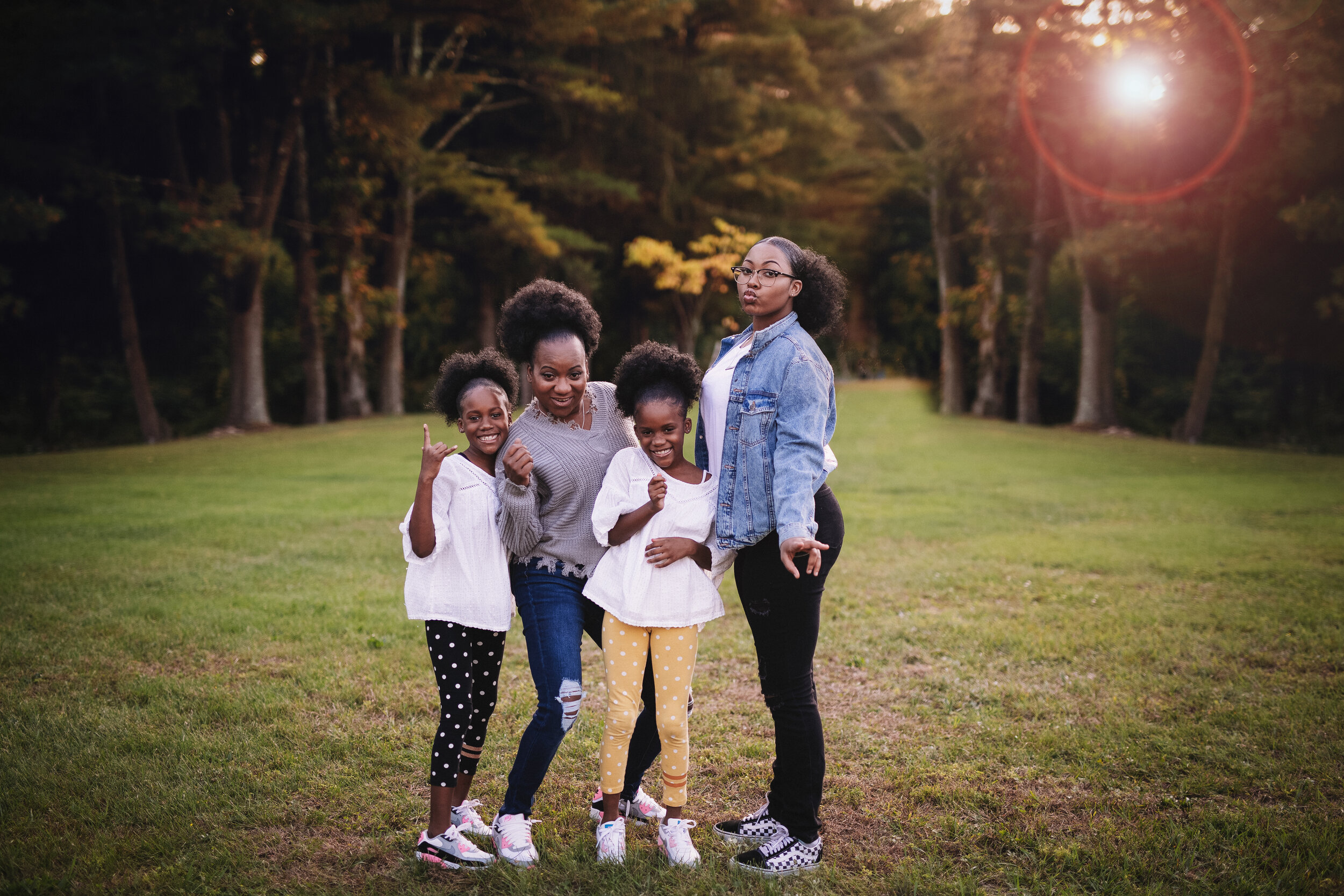  Family of sisters strike power poses for a silly photo during their portrait session 