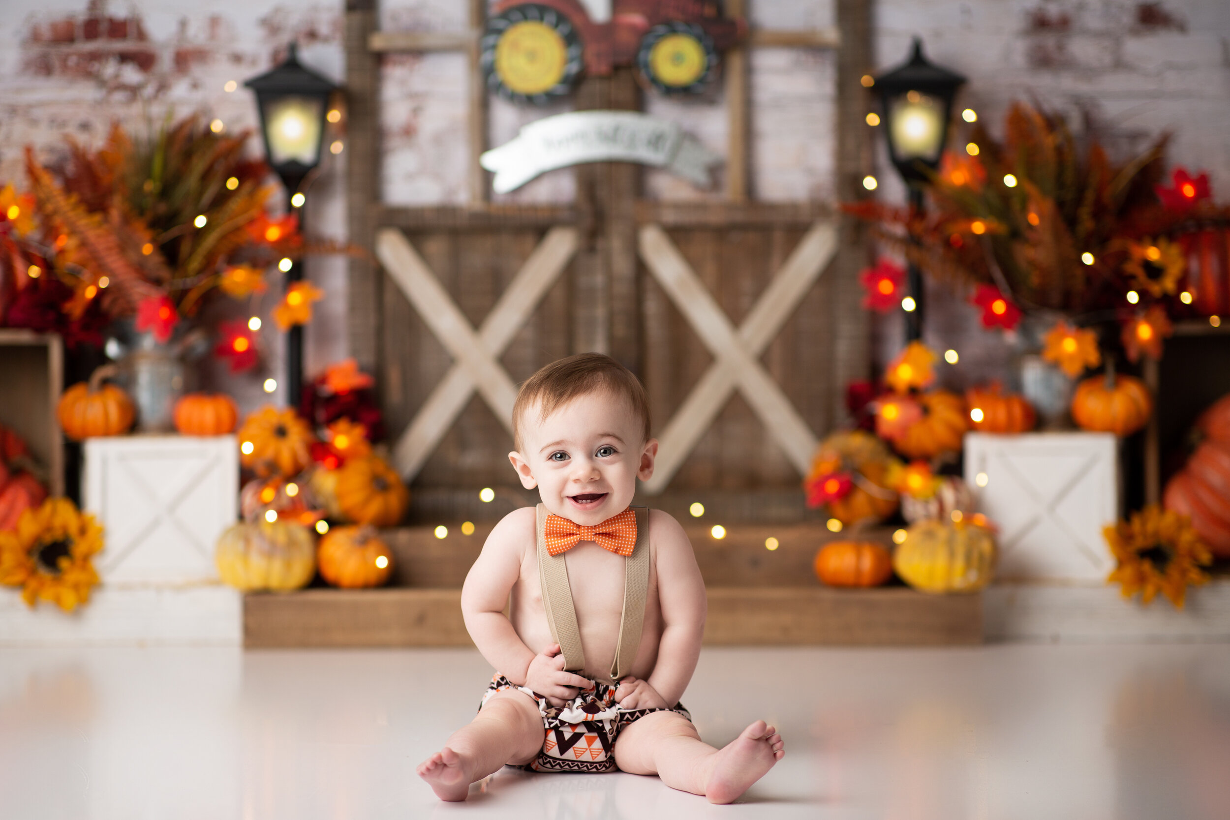  Fall baby birthday photoshoot with pumpkins and barn doors 