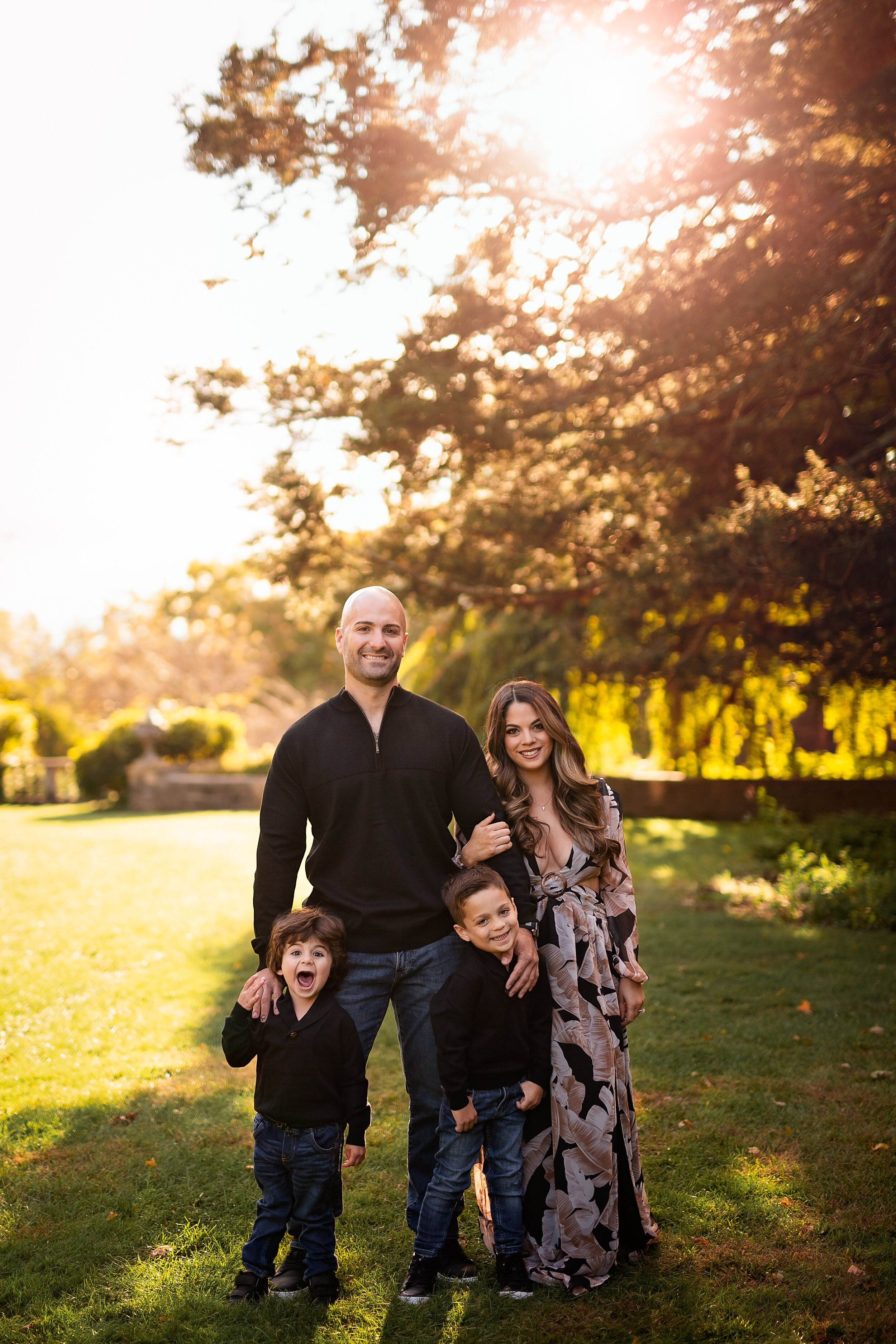  Dad hugs his two boys while his wife links her arms with his during a family photoshoot in New York 