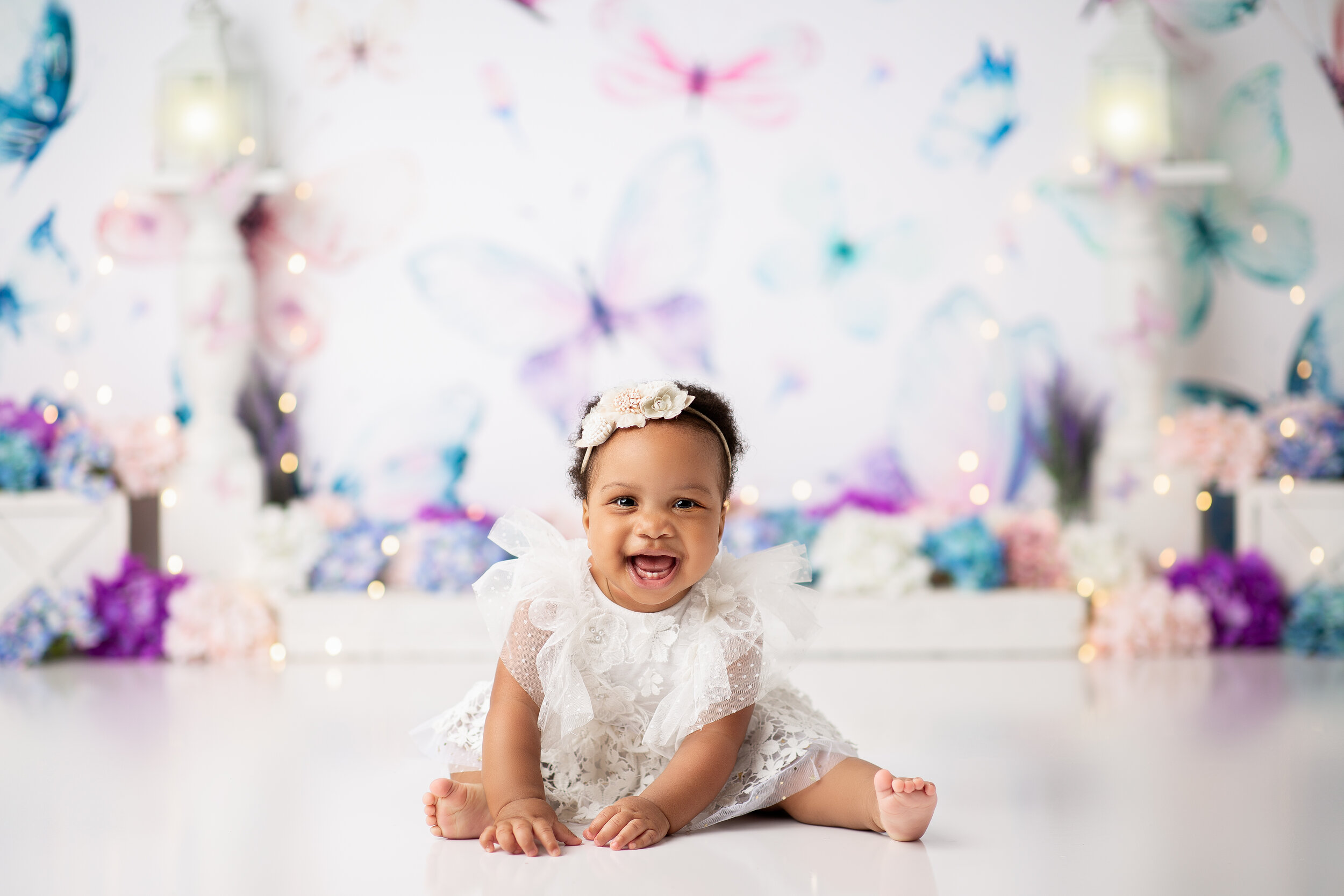  Young child giggles during milestone photoshoot in photographer’s studio in the Tri-State area 