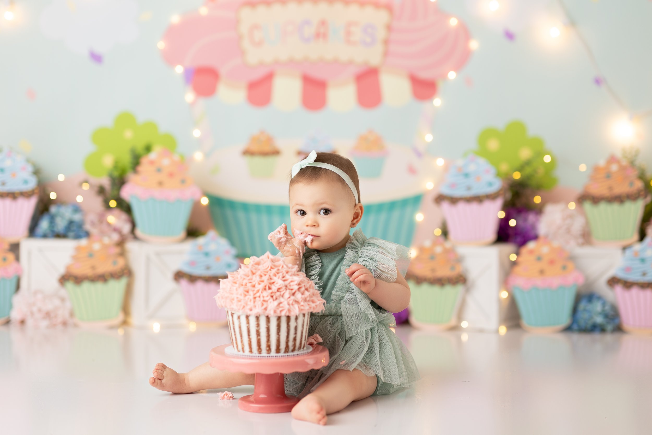  Baby girl eating giant cupcake in New Jersey photo studio 