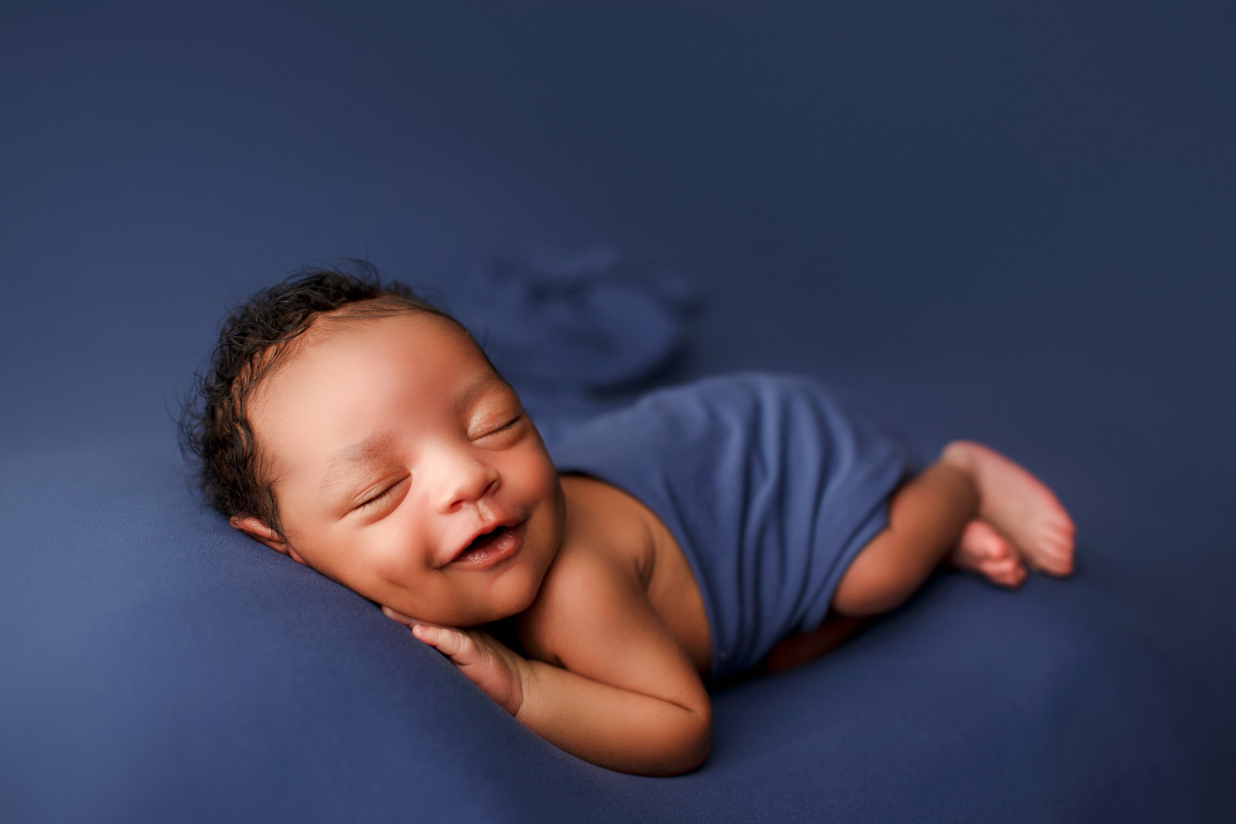  Smiling baby in blue blanket  