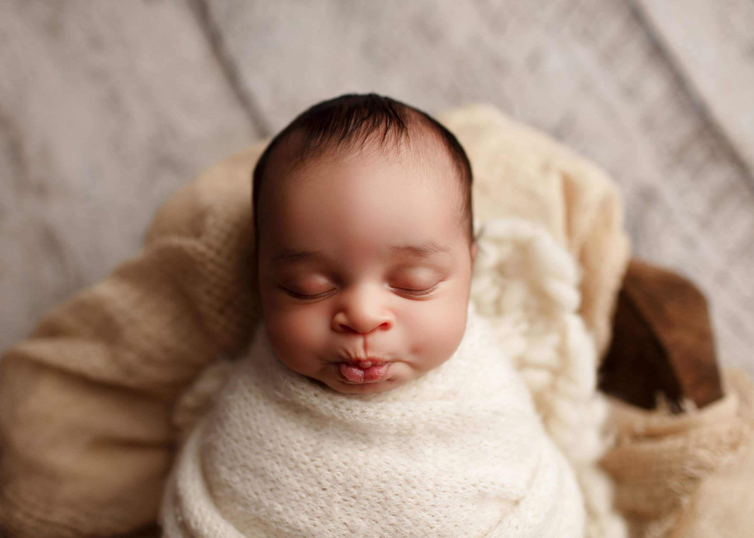  Baby pulls a funny face in his sleep during his New Jersey newborn photoshoot 