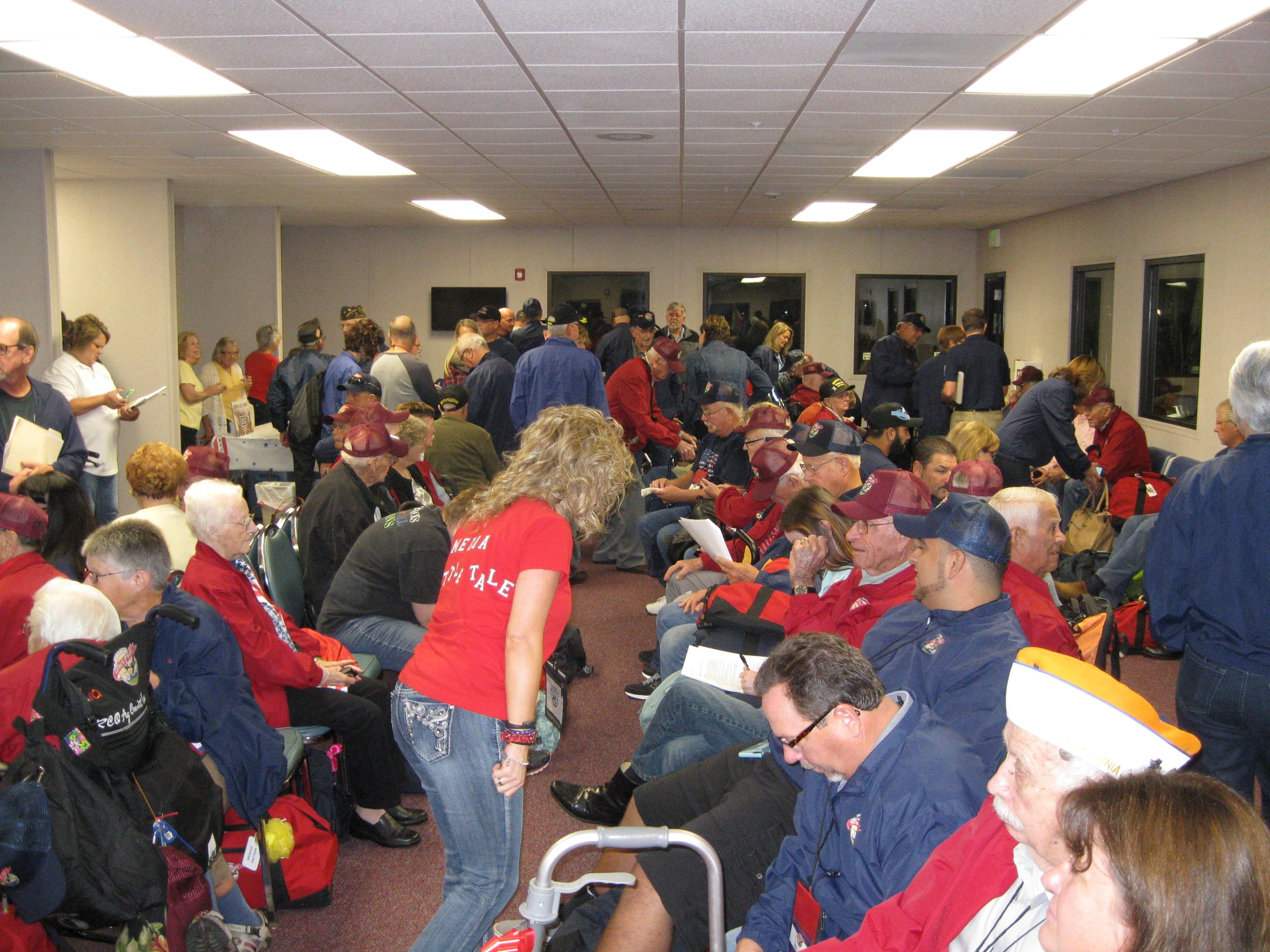 Veterans, their Honor Flight guardians, and other volunteers assemble at Castle Airport in Atwater, Merced County. Photo by Steve Newvine