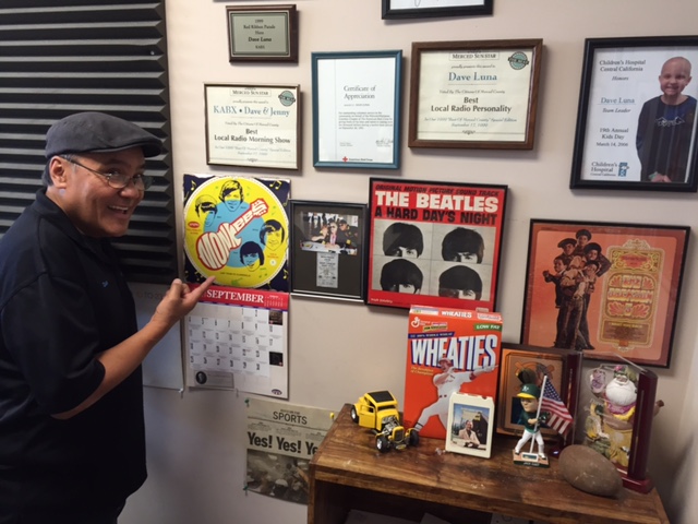Dave Luna keeps rock and roll photos and vintage album covers on the studio wall at the Radio Merced offices on Main Street in Merced. Photo by Steve Newvine