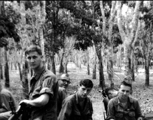 Bill Newvine didn’t seek the spotlight or even the camera’s lens in this photo from his time in Vietnam. He’s the soldier wearing glasses. Photo: Alpha Association