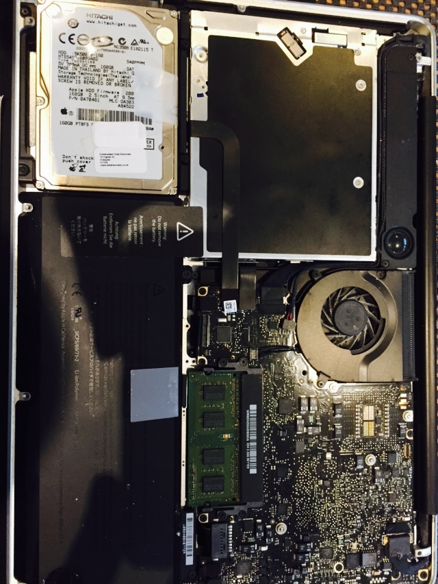 Taking the base off the macbook to remove the hitachi hard drive
