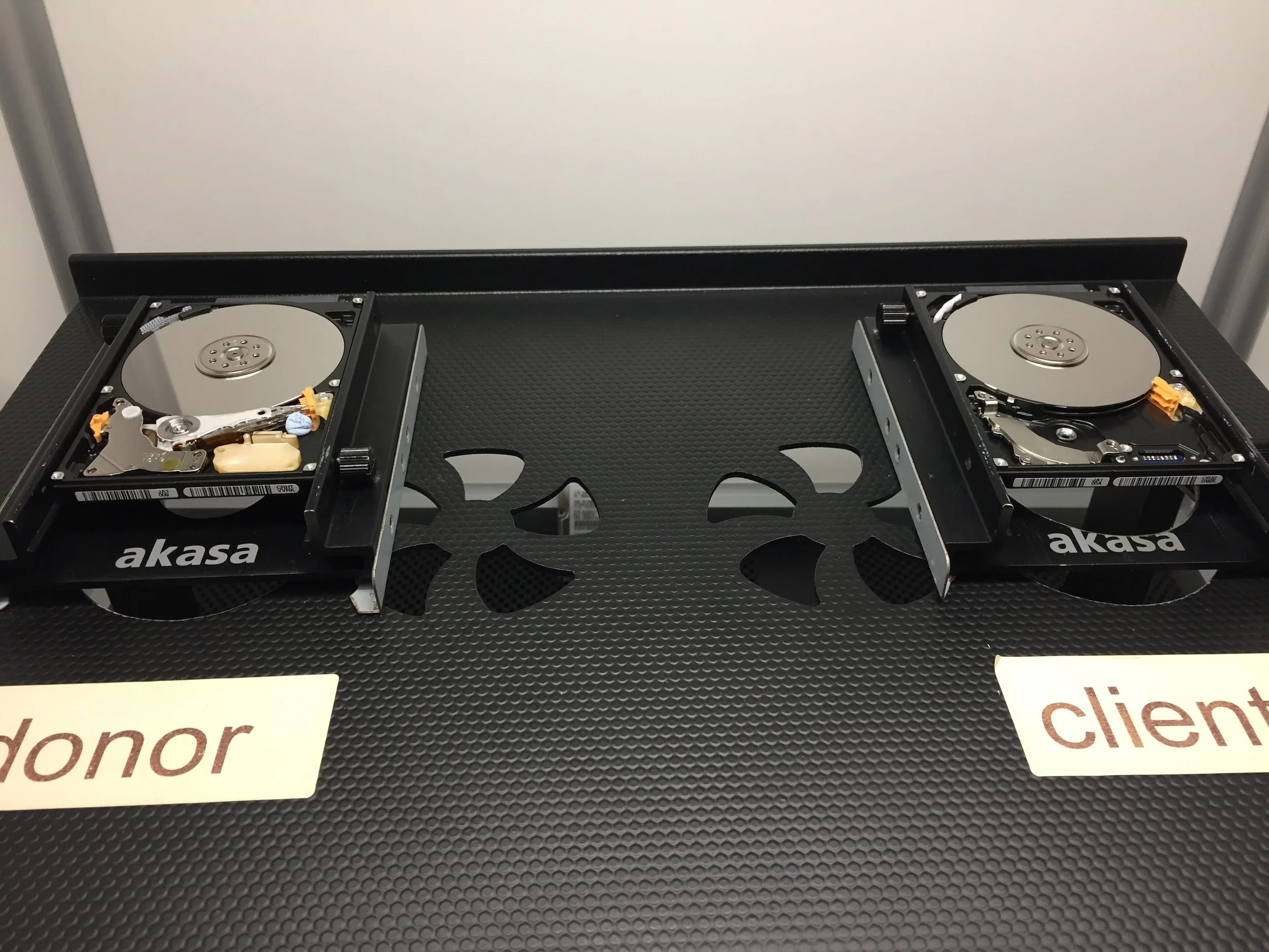 Both drives opened up on my bench. Heads out the client drive and I will move over the parts from the donor. 