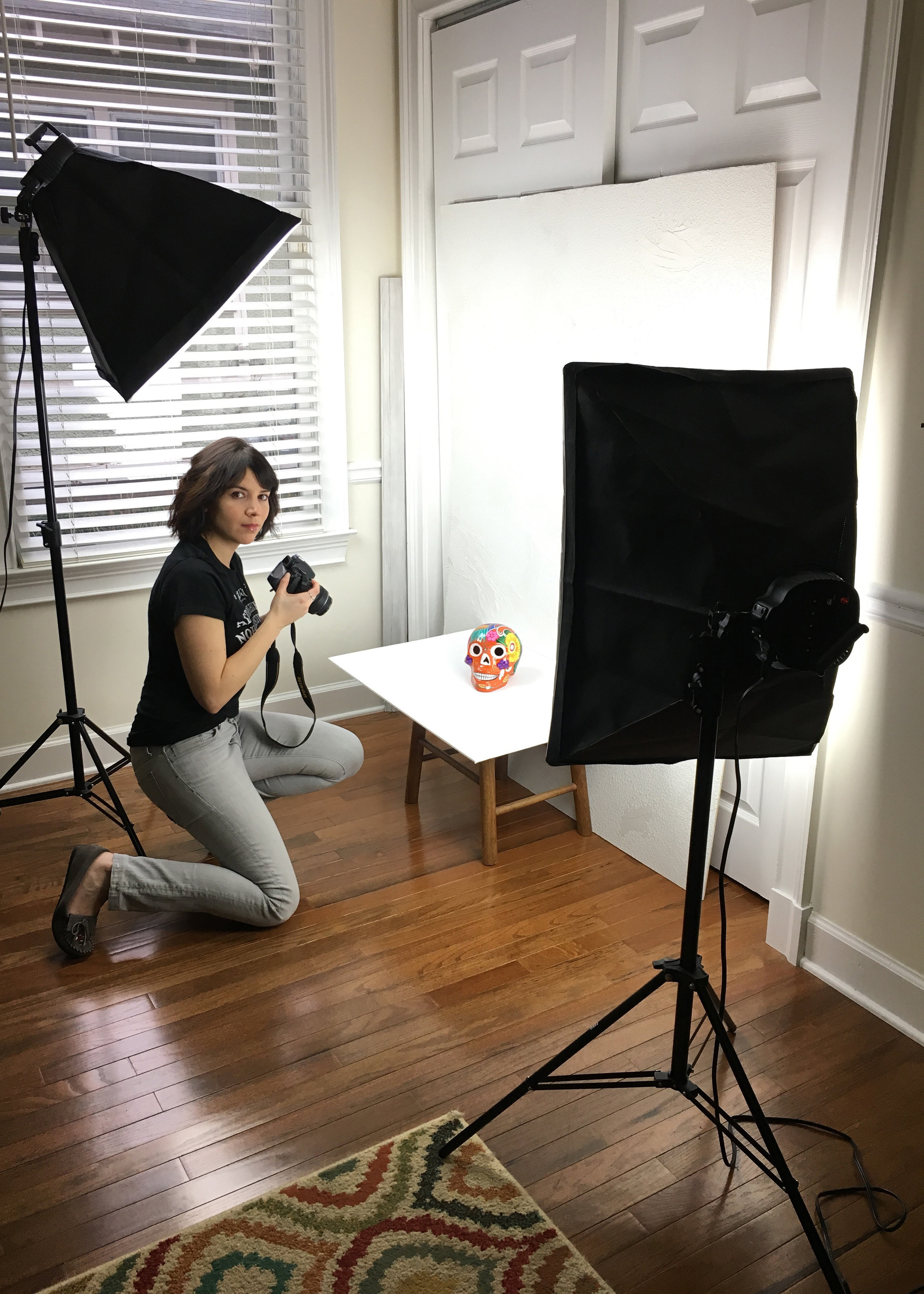 Angelique snaps pictures of merchandise for her website at home. (Photo Courtesy: Angelique Sloan)