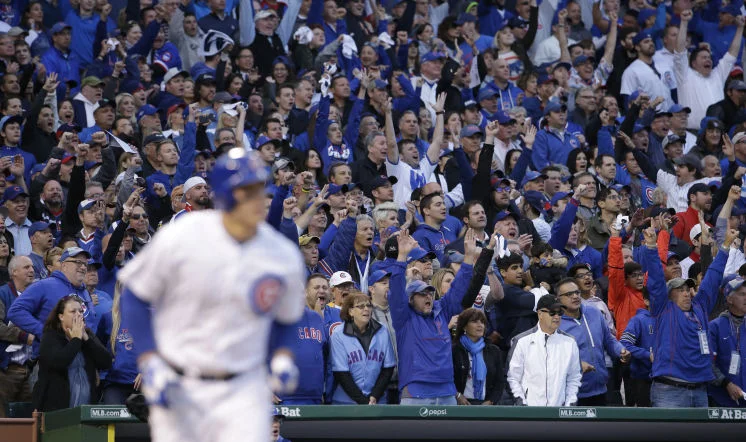 Fans cheer as Chicago Cubs' Anthony Rizzo (44) hits a home run against the St. Louis Cardinals during the sixth inning of Game 4 in baseball's National League Division Series, Tuesday, Oct. 13, 2015, in Chicago. (AP Photo/Nam Y. Huh)
