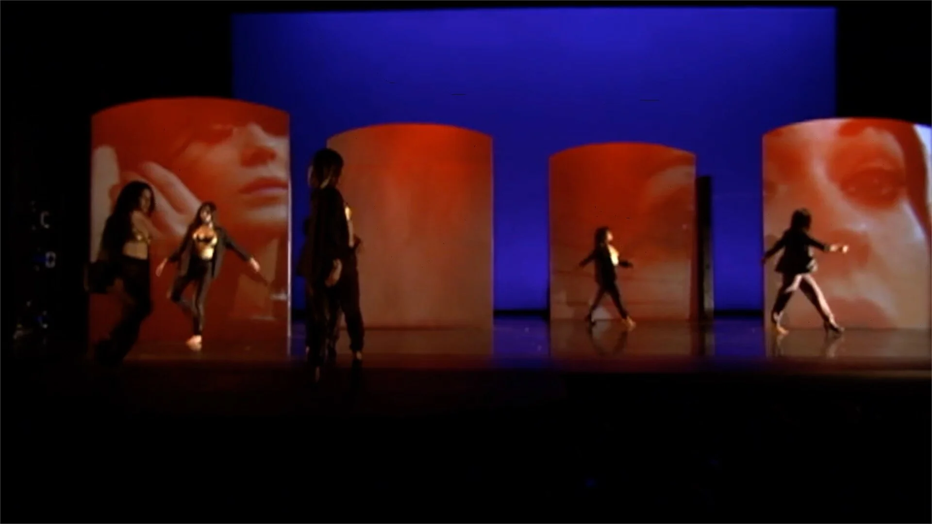 Large screens by Mitchell Barutha project video by Carolina Loyola as part of the stage installation.