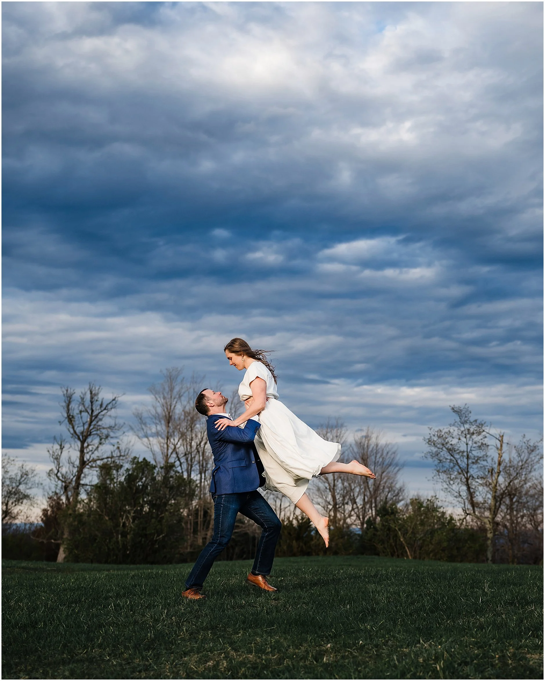Groom lifting his bride in the air during Soft light engagement photography at Minnewaska State Park