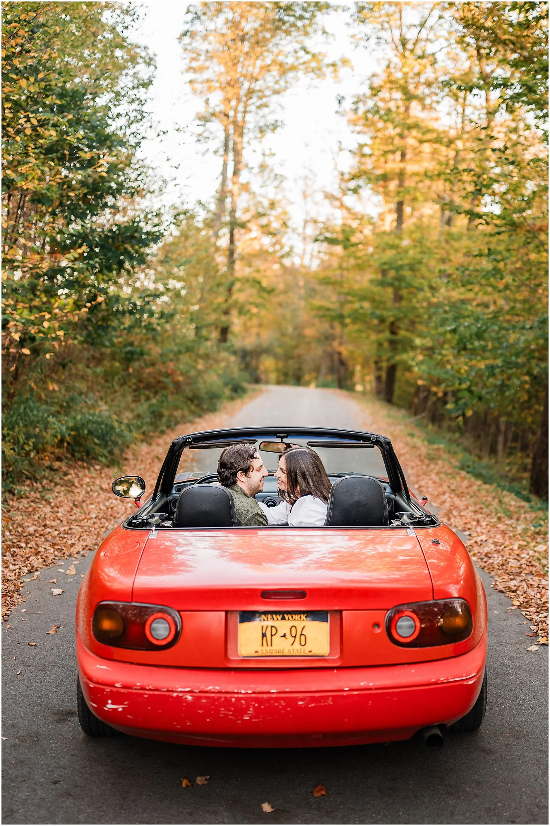 Timeless couple portrait with red convertible and autumn foliage in Upstate New York