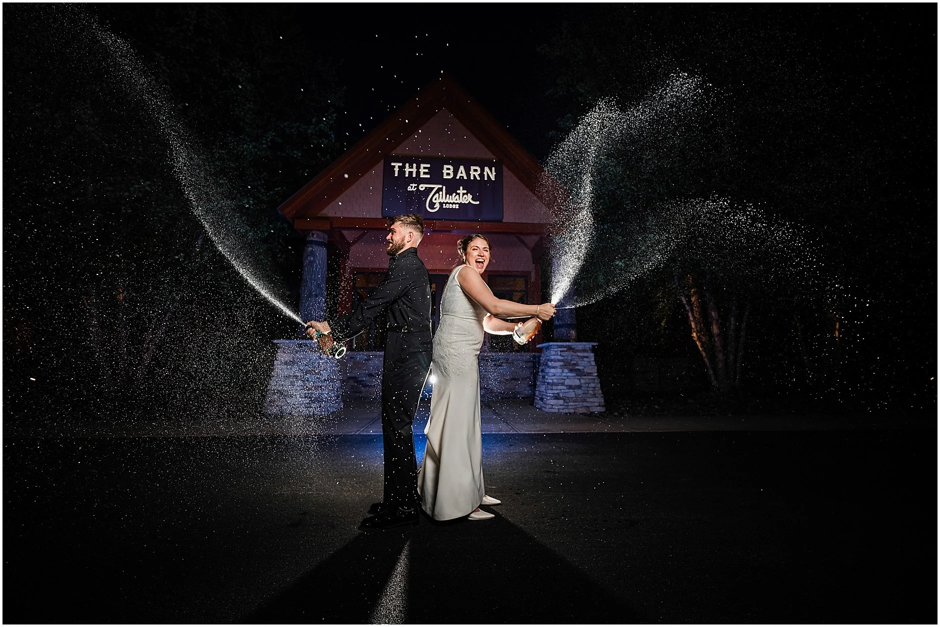 Bride and groom popping champagne outside of their Upstate, NY wedding venue after a day of celebration.