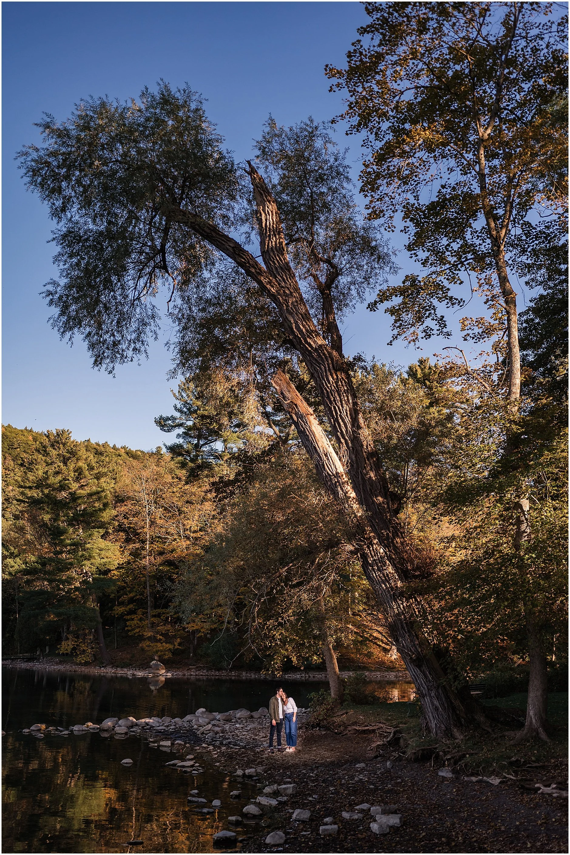 Fall foliage engagement photo near Otsego Lake shoreline