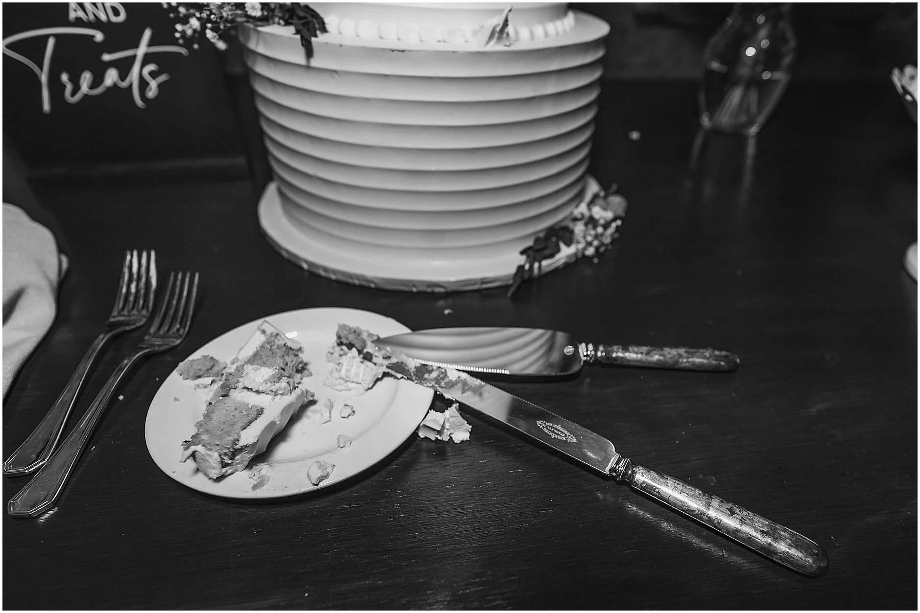 Black and white photo of the the cake knives during a spring wedding in New York.