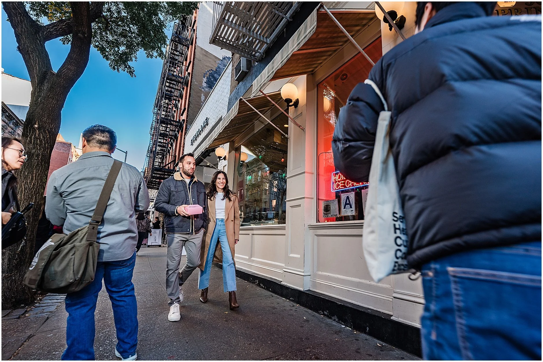 Timeless candid of couple walking down the street in Manhattan for their engagement session