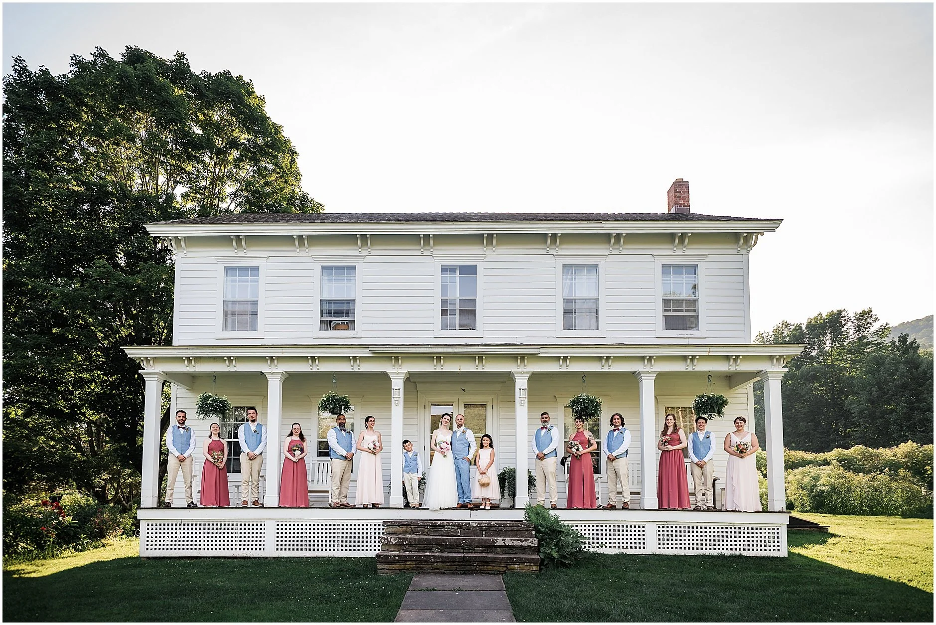 Wedding party photo standing on the porch at The Inn at West Settlement