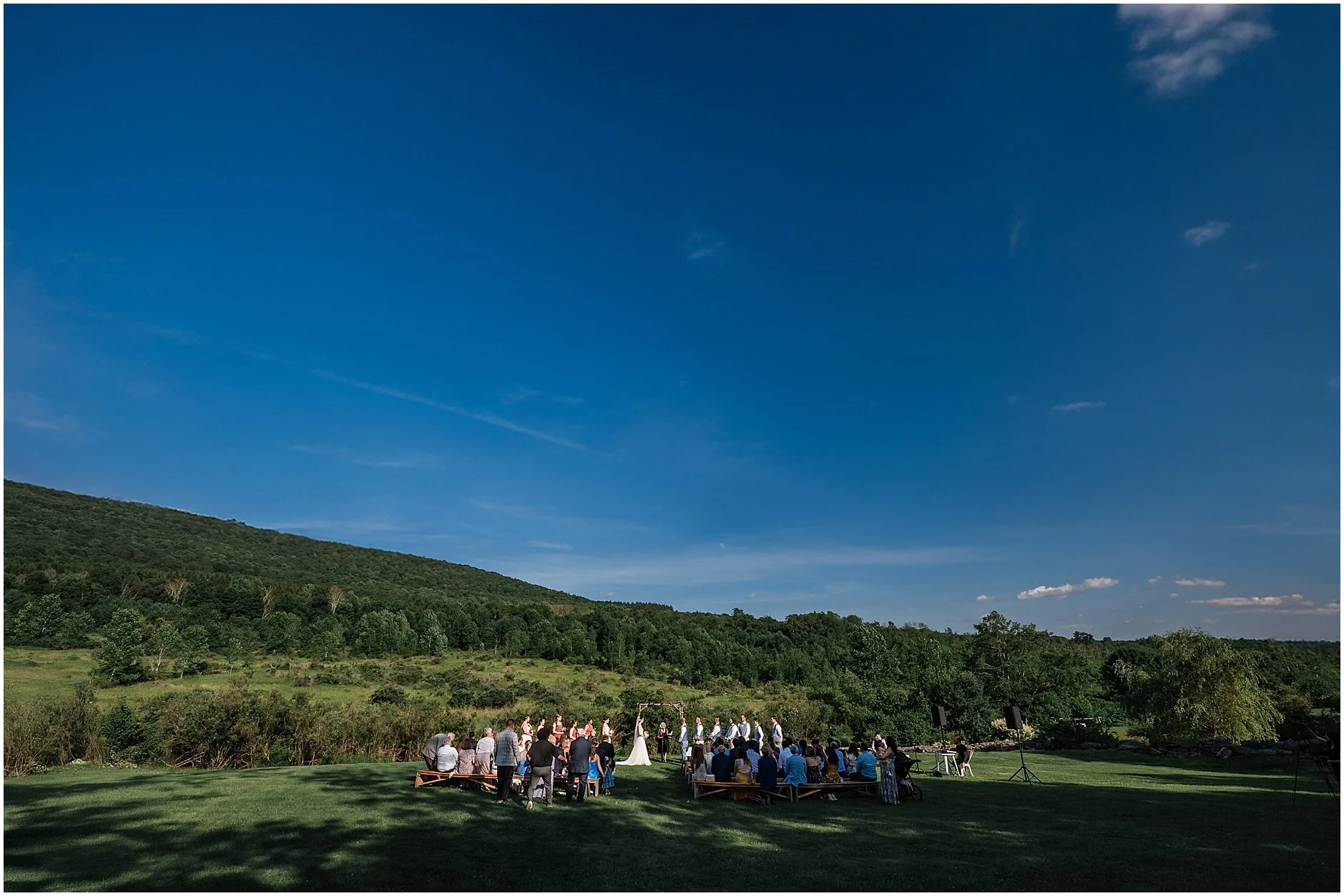 Wide shot of a wedding ceremony at The Inn at West Settlement tucked in the heart of the Catskill Mountains, NY