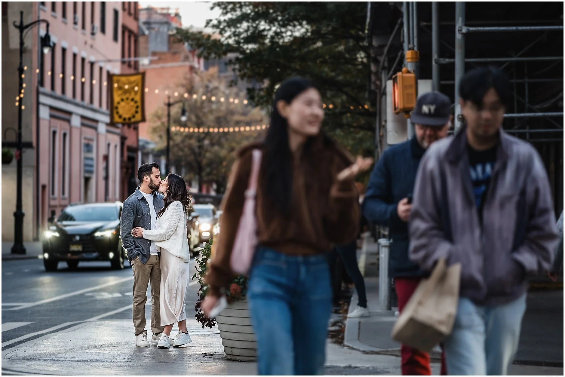 Couple sharing a kiss in the streets of Manhattan during their editorial engagement session
