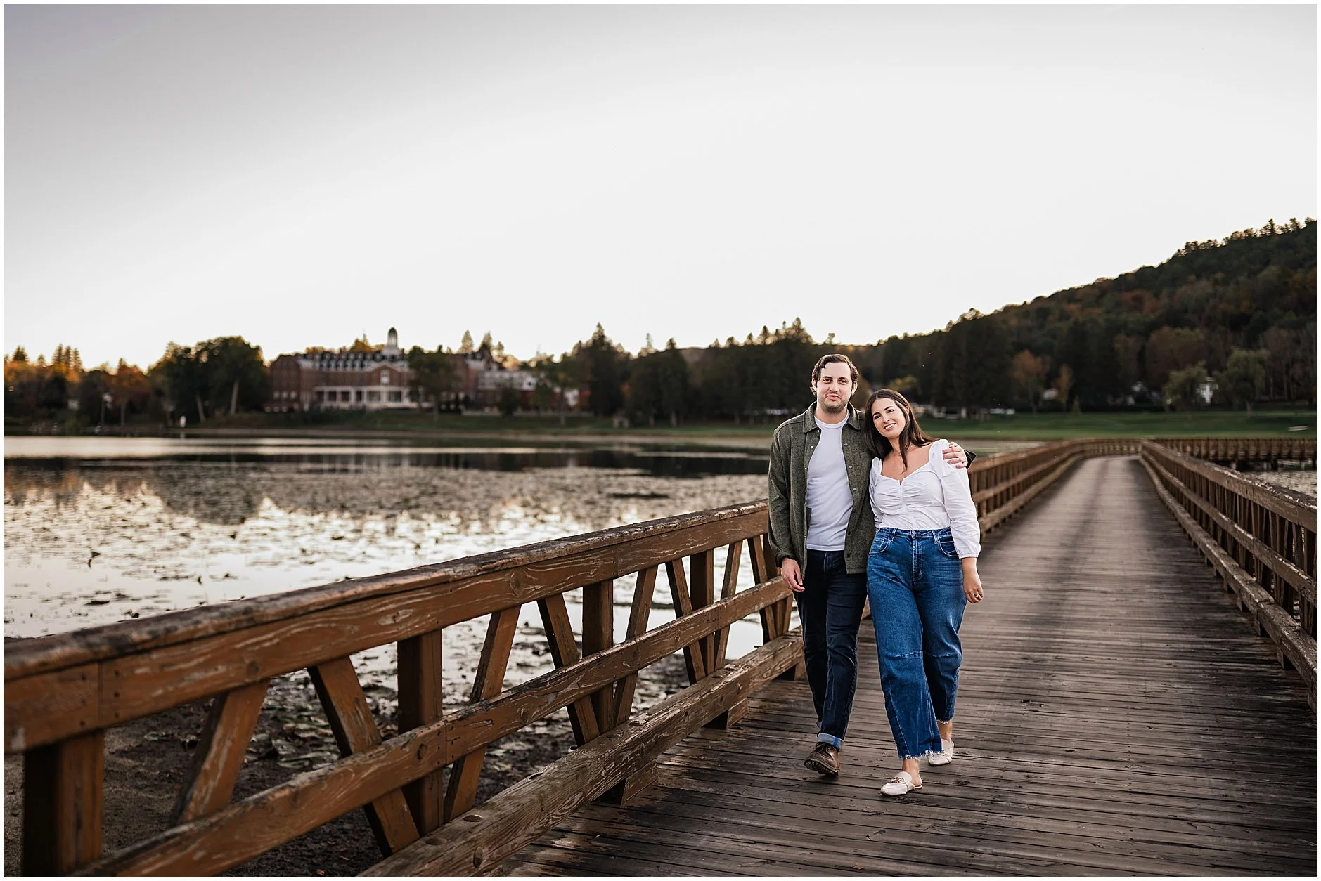 Romantic fall engagement photo with The Otesaga in distance