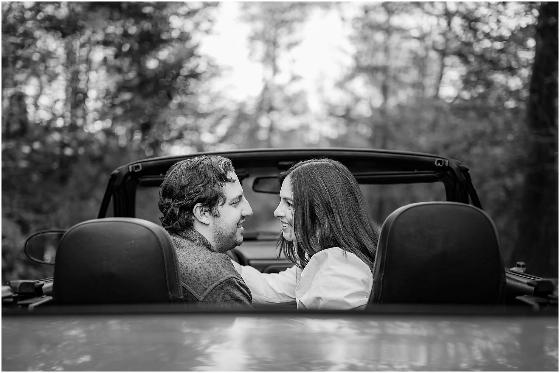 Cinematic engagement photo with red convertible in Cooperstown NY