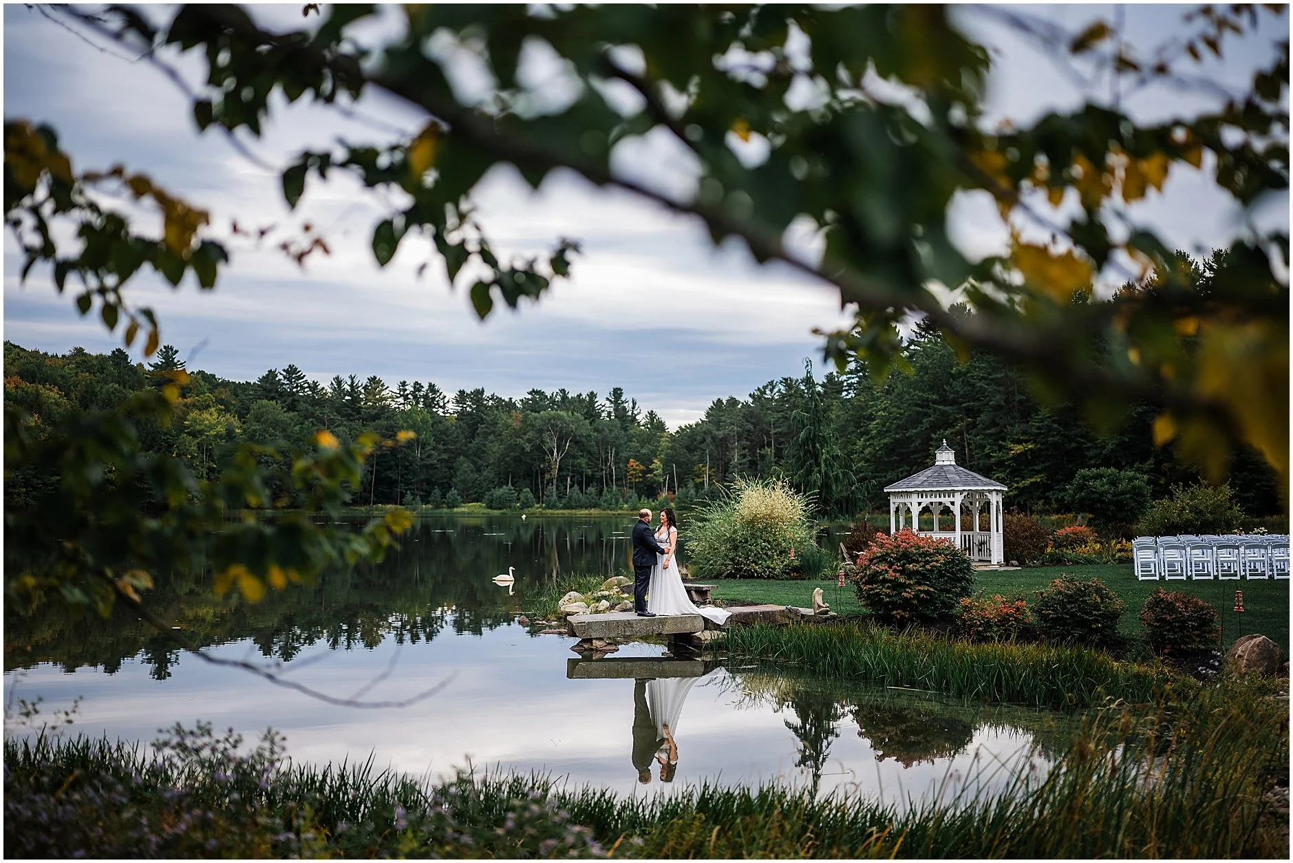 Newlyweds sharing a quiet moment surrounded by the water at The Rosemary at Spano Lake in Cooperstown, New York