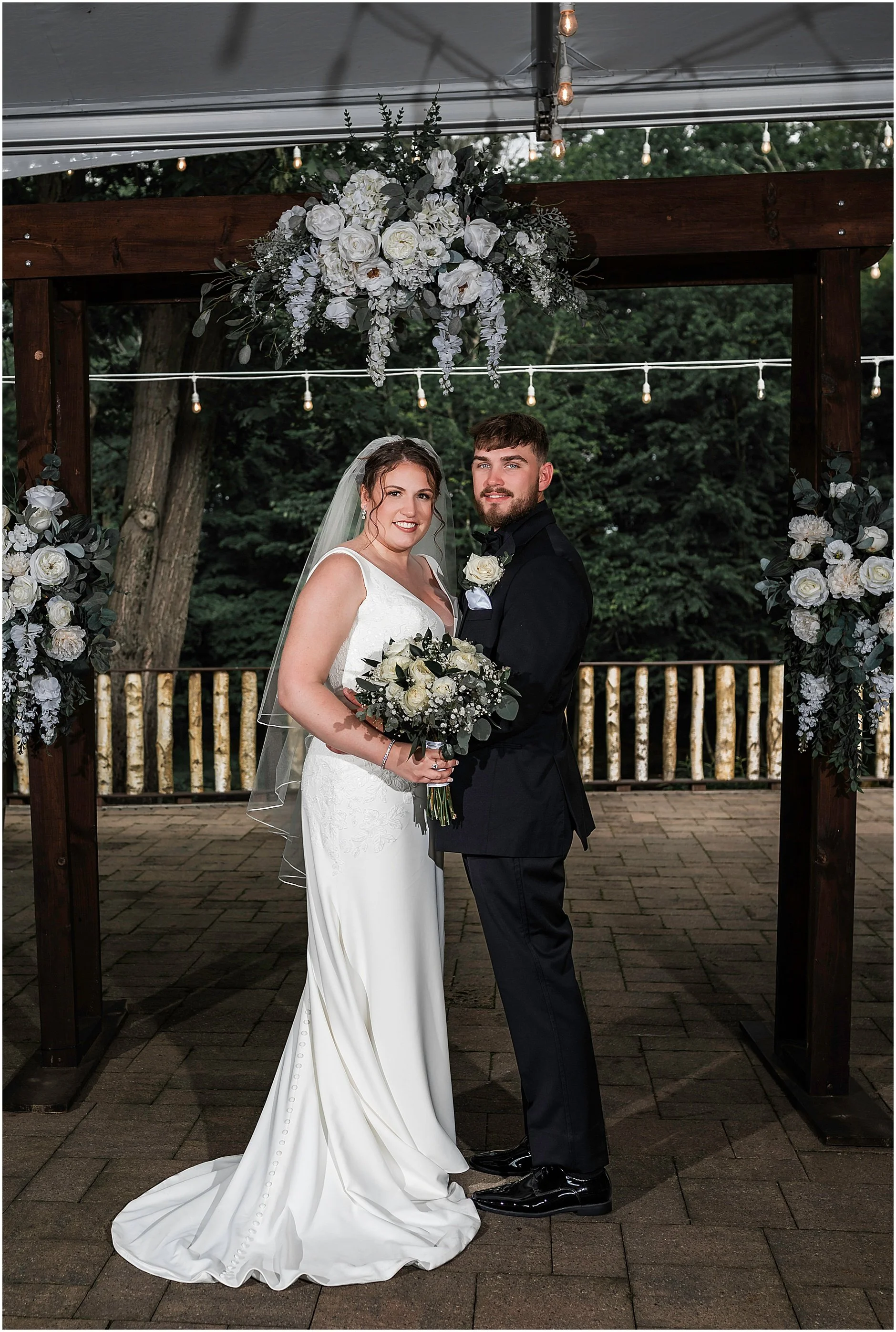 Upstate New York bride and groom smiling for portraits after their ceremony.