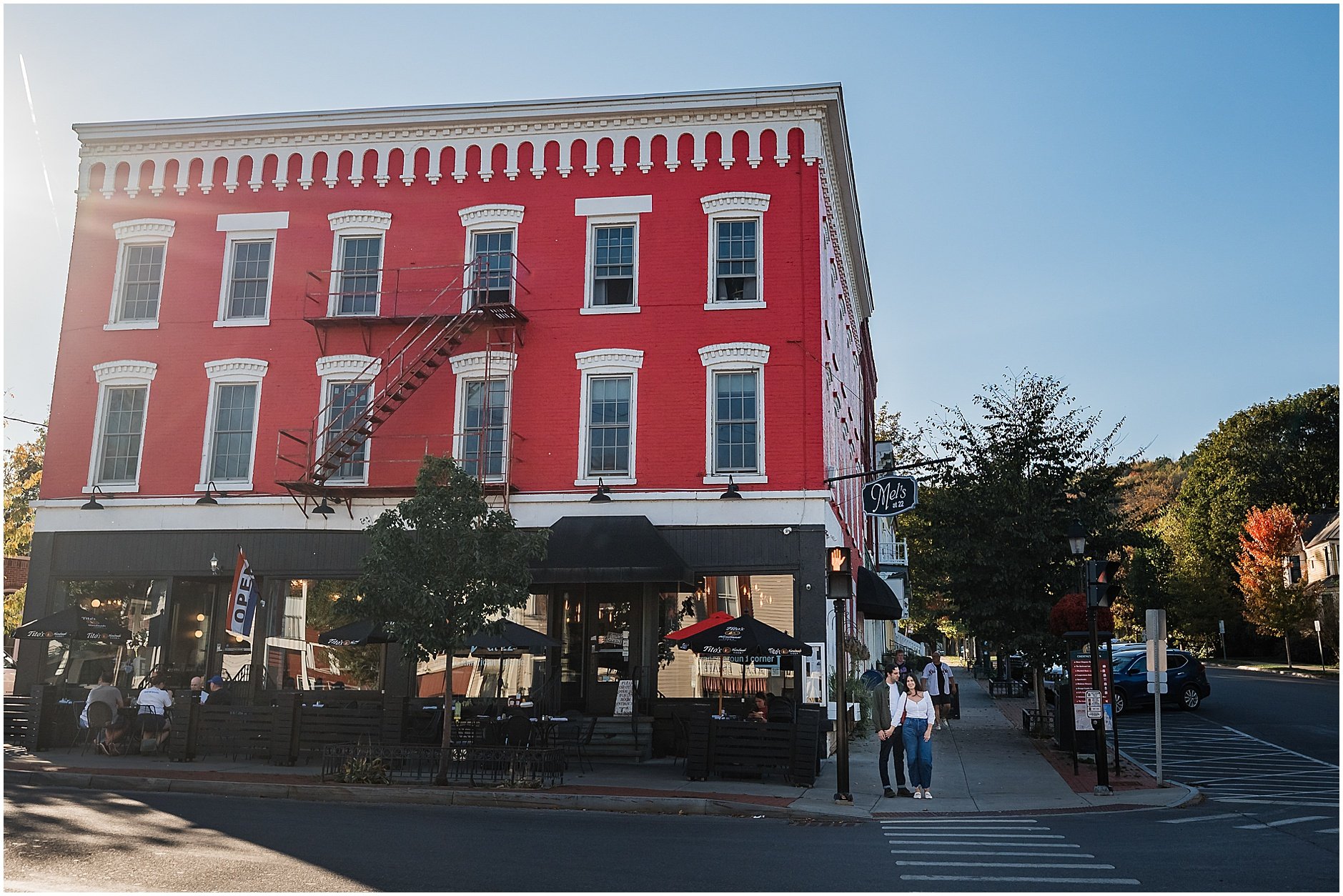Romantic sidewalk portrait in Cooperstown NY engagement session outside Mel's 22